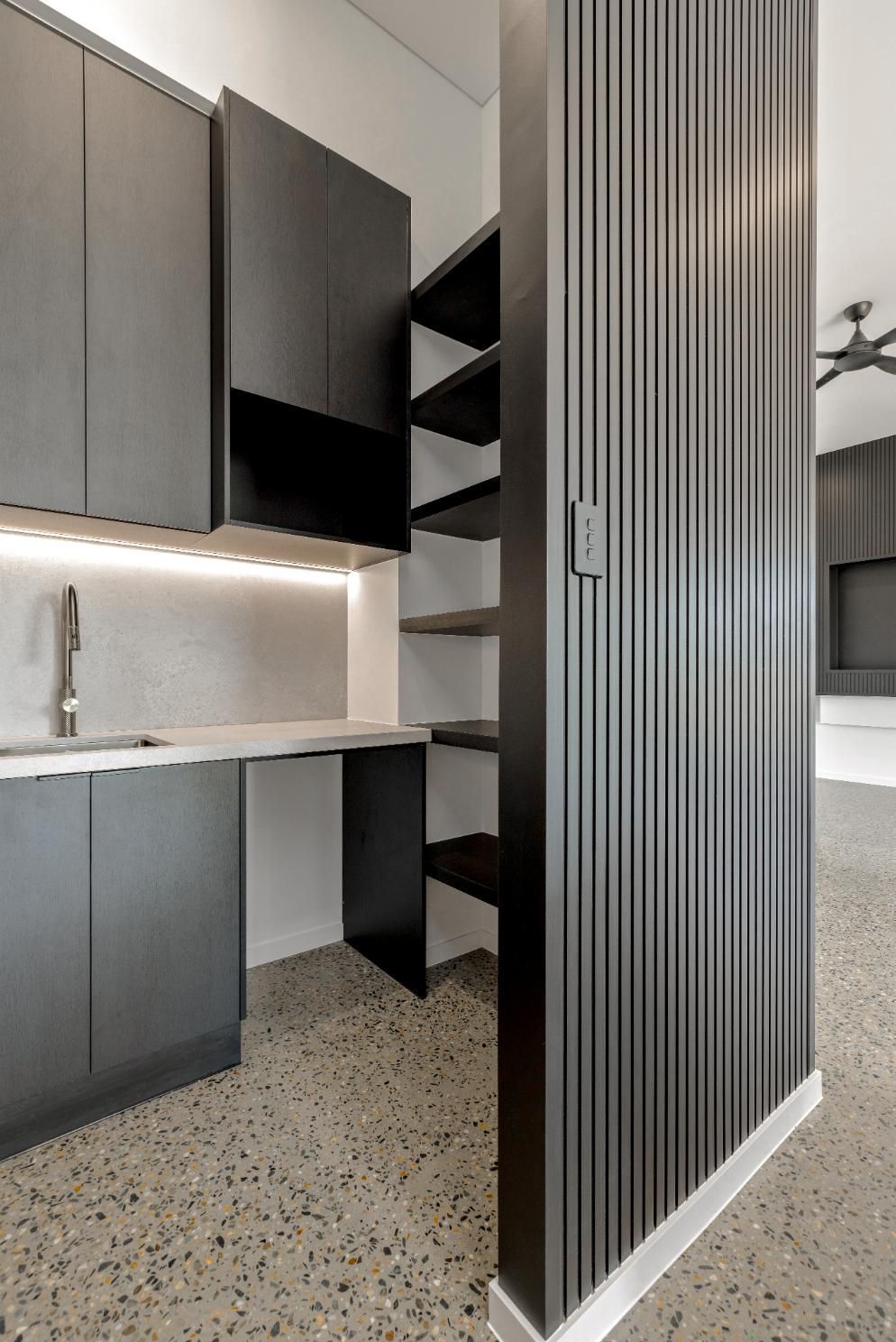 A Kitchen with Black Cabinets, a Sink, and Shelves — Ashlee Jones Homes in Gordonvale, QLD