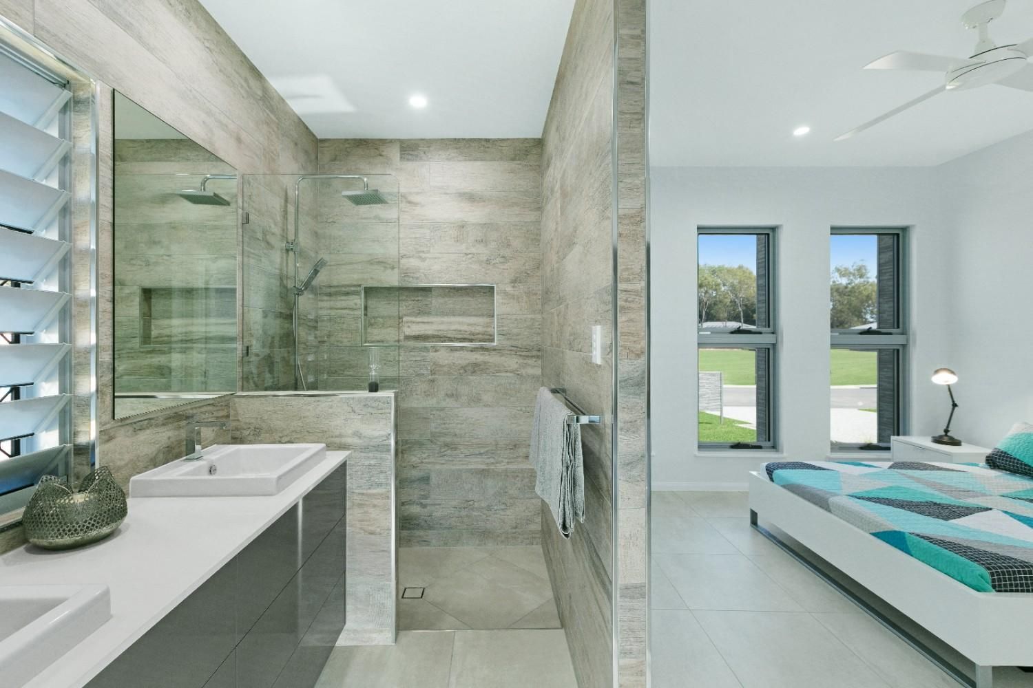 A Bathroom With a Walk in Shower Next to a Bedroom — Ashlee Jones Homes in Gordonvale, QLD