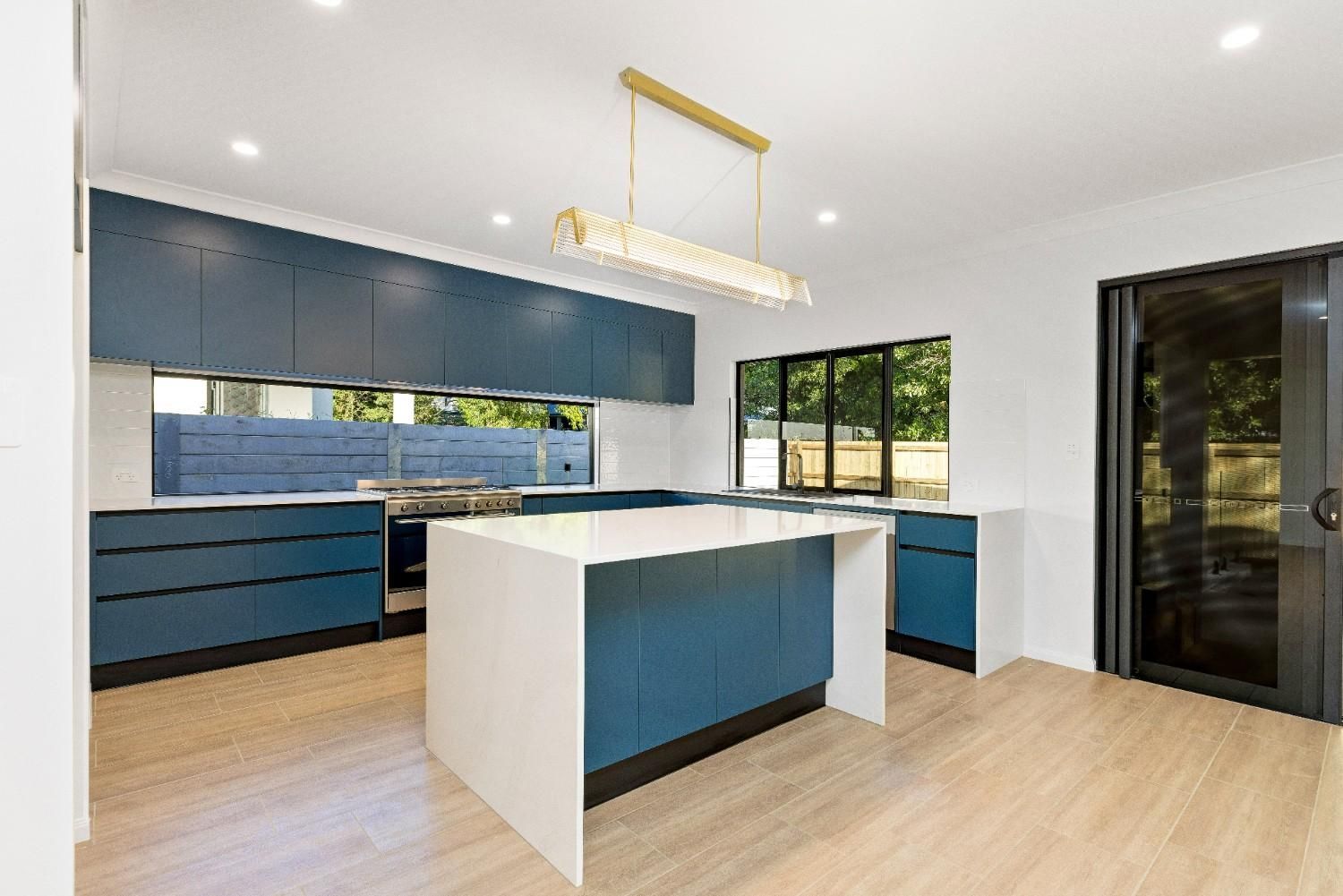 A Large Empty Room With a View of a Grassy Field — Ashlee Jones Homes in Gordonvale, QLD