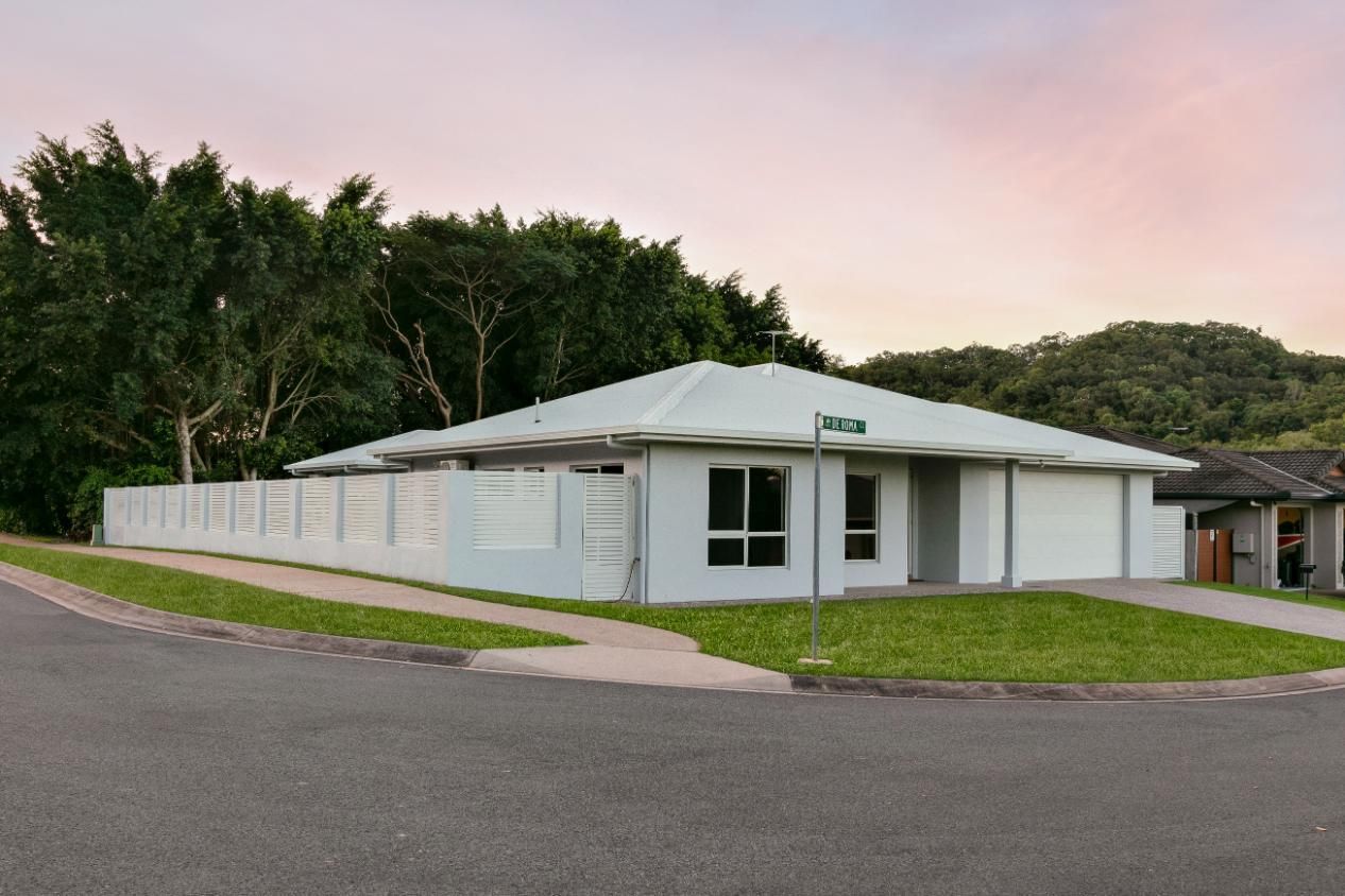 A White House With a Fence in Front of It — Ashlee Jones Homes in Gordonvale, QLD