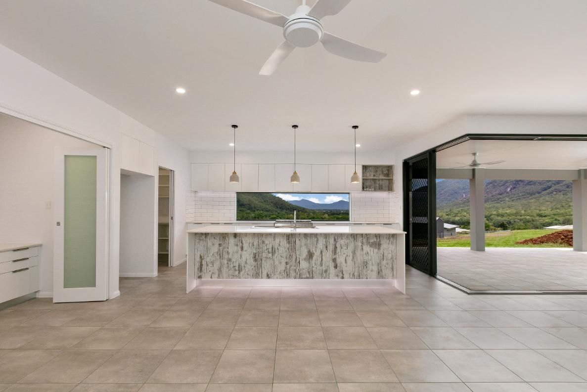 A Kitchen With a Ceiling Fan and a Large Window — Ashlee Jones Homes in Gordonvale, QLD