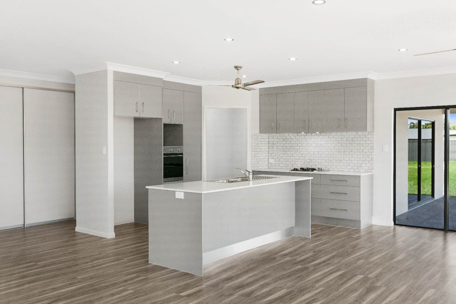 An Empty Kitchen With a Large Island in the Middle of the Room — Ashlee Jones Homes in Gordonvale, QLD