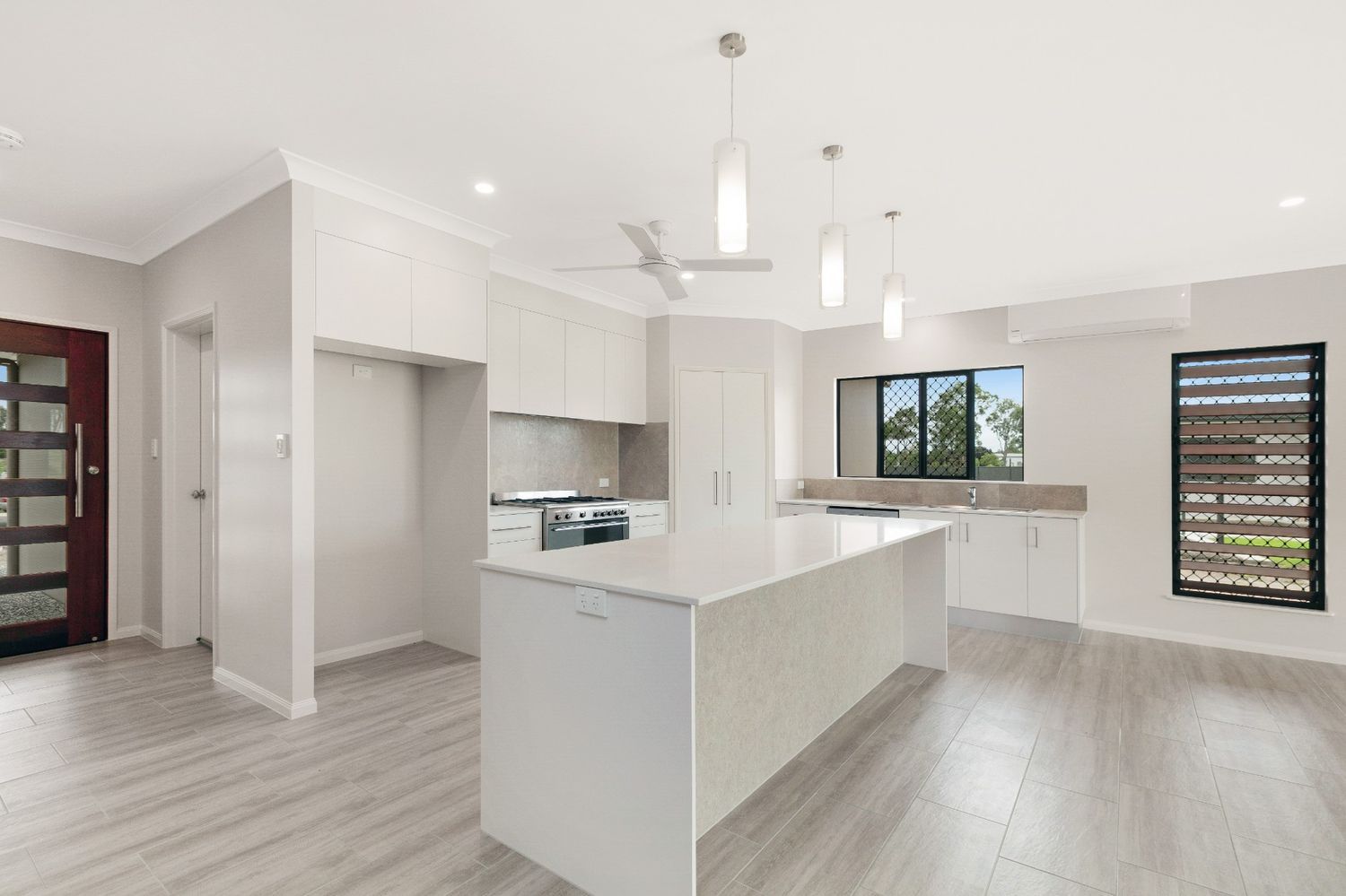 There is a Large Island in the Middle of the Kitchen — Ashlee Jones Homes in Gordonvale, QLD