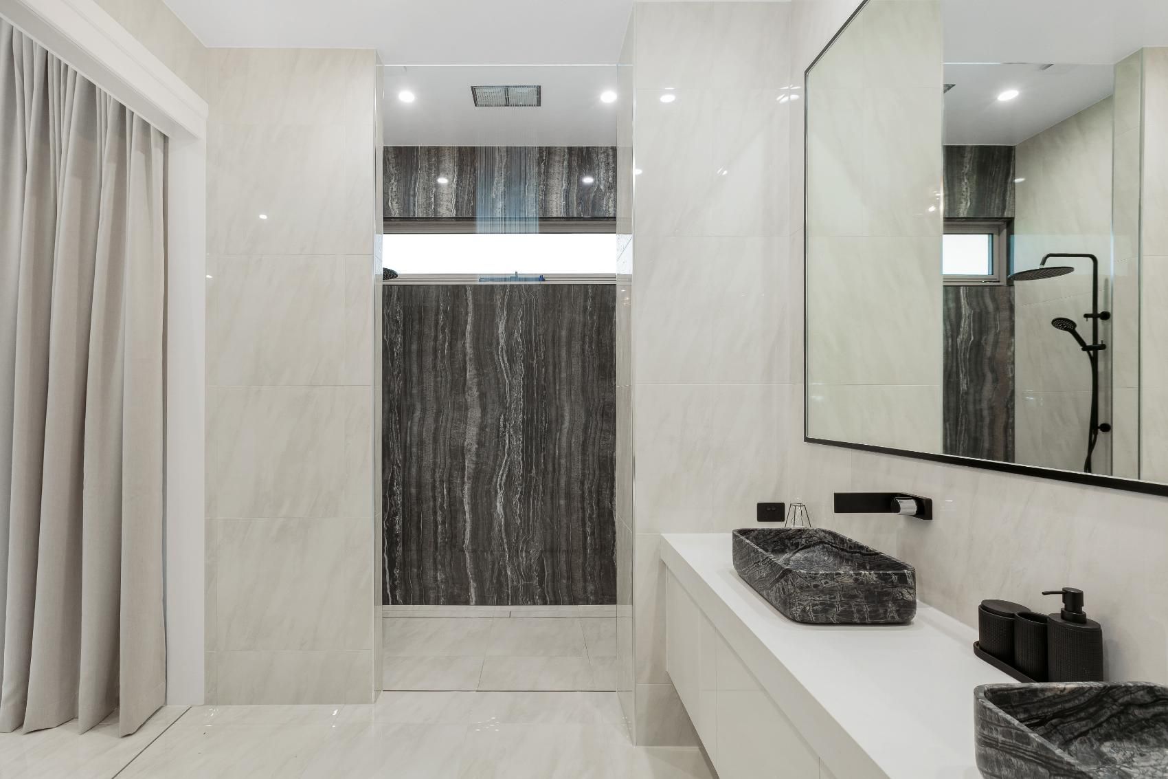 A Bathroom With Two Sinks and a Large Mirror — Ashlee Jones Homes in Gordonvale, QLD