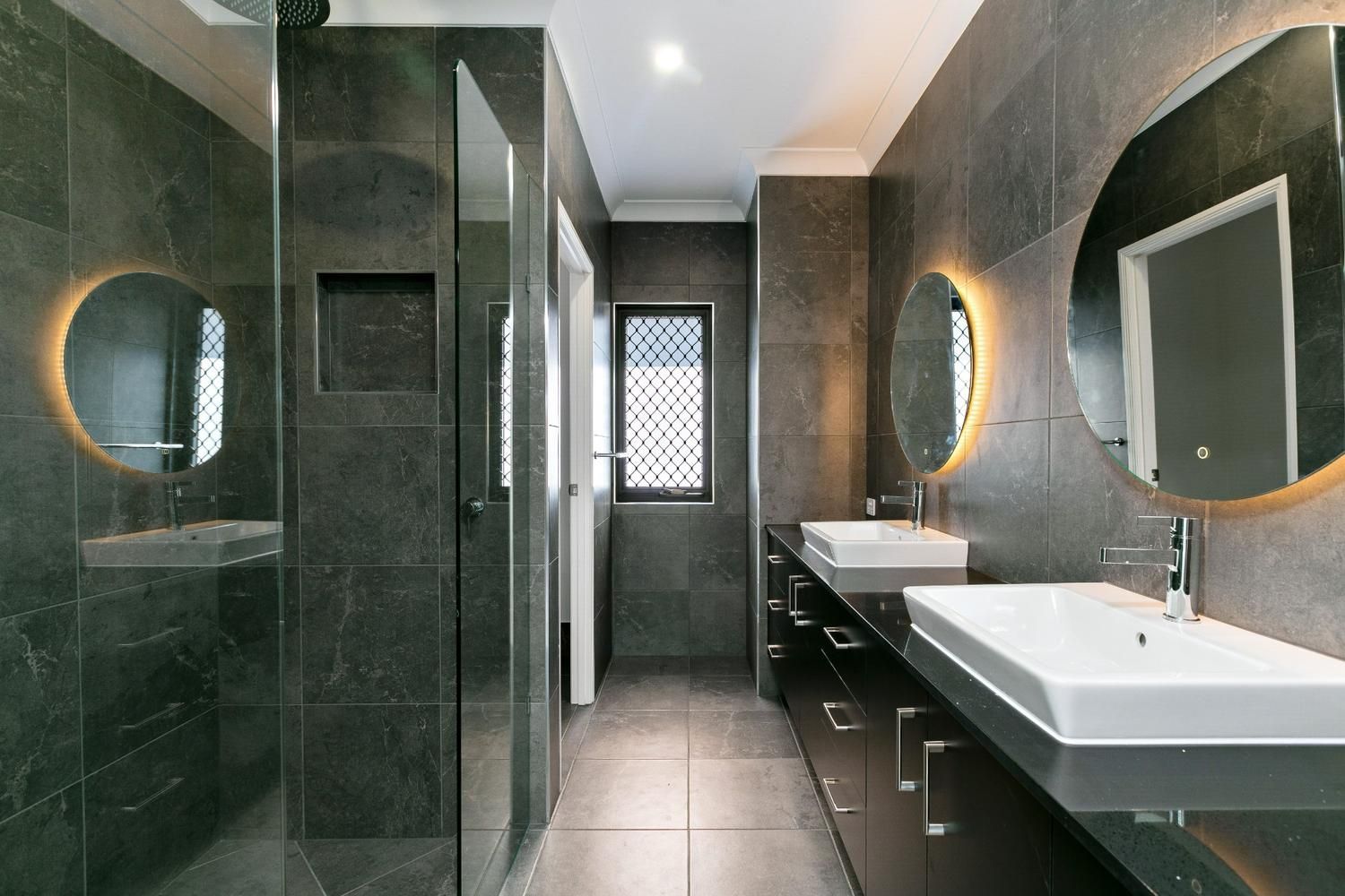 A Bathroom With Two Sinks and a Walk in Shower — Ashlee Jones Homes in Gordonvale, QLD