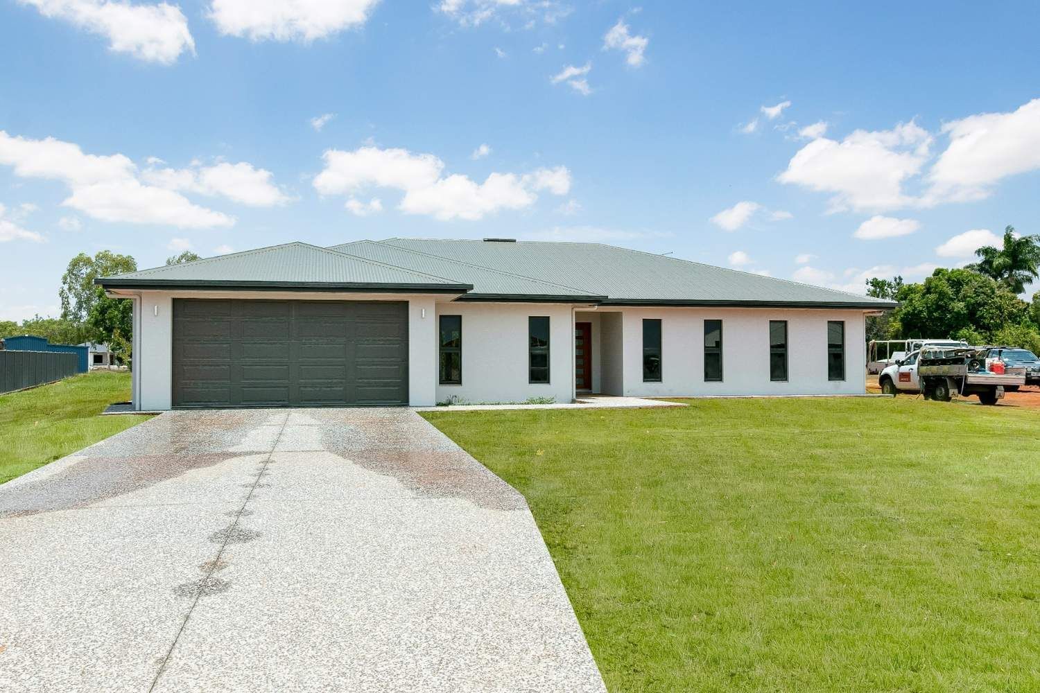 A White House With a Gray Garage Door — Ashlee Jones Homes in Gordonvale, QLD