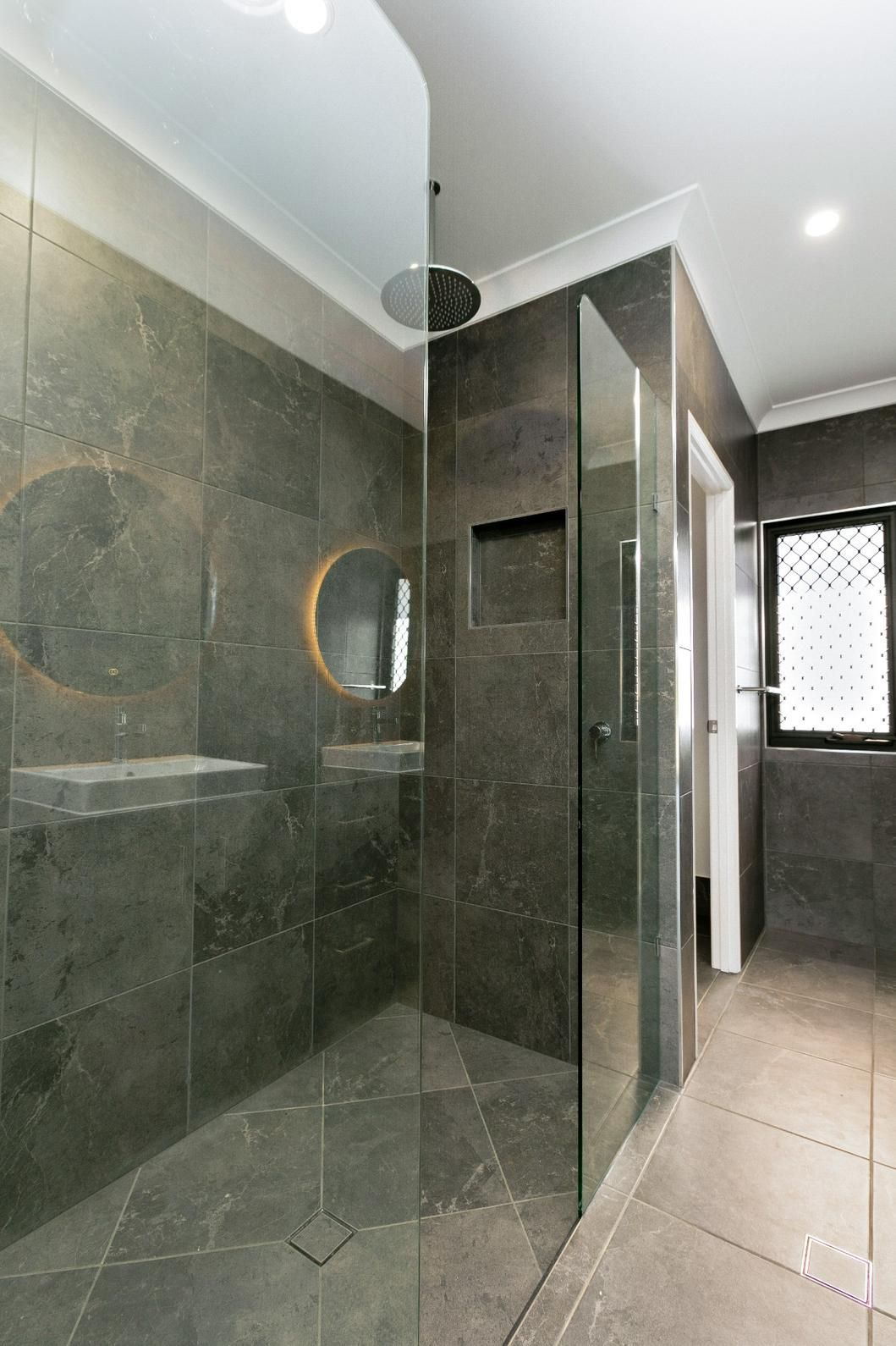 A Bathroom With a Walk in Shower and a Sink — Ashlee Jones Homes in Gordonvale, QLD