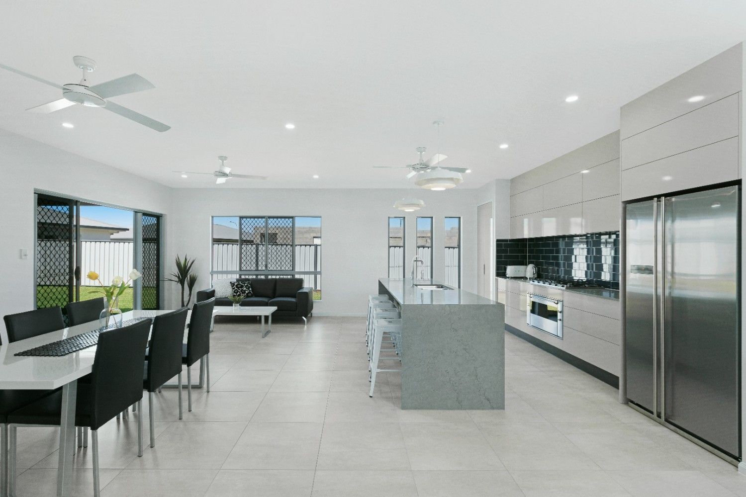 A Kitchen With Stainless Steel Appliances and a Large Island — Ashlee Jones Homes in Gordonvale, QLD