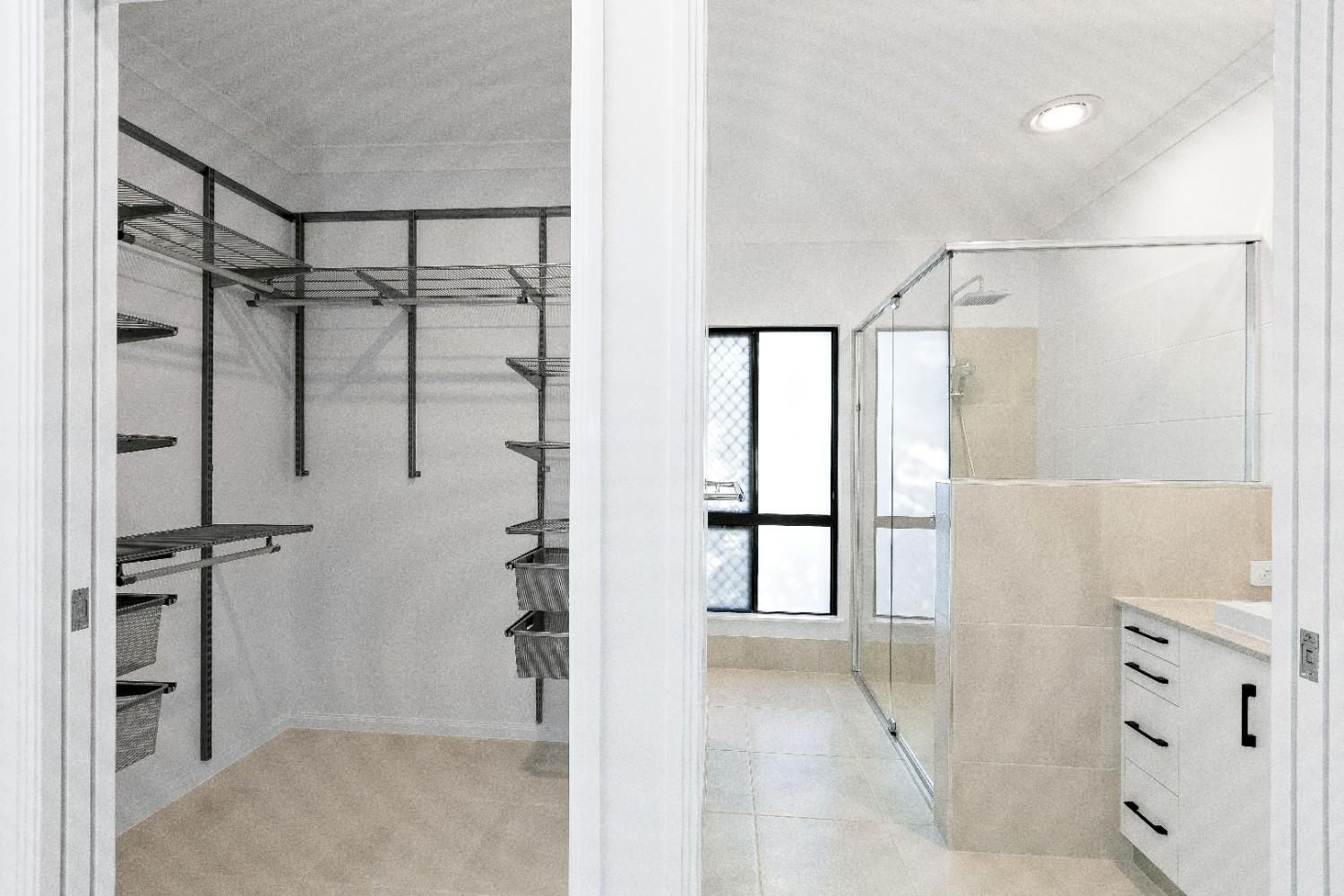 There is a Walk in Closet and a Bathroom With a Walk in Shower — Ashlee Jones Homes in Gordonvale, QLD