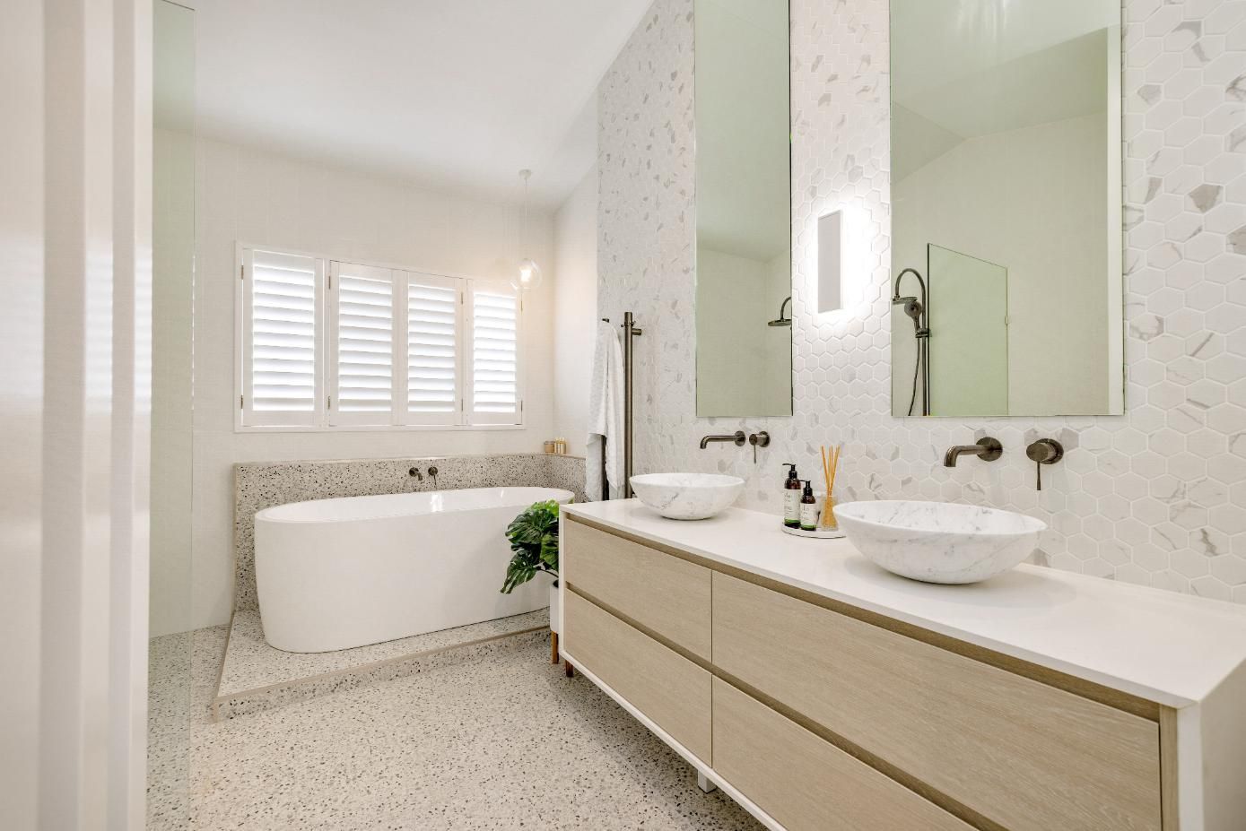 A Bathroom With Two Sinks, a Bathtub and Two Mirrors — Ashlee Jones Homes in Gordonvale, QLD