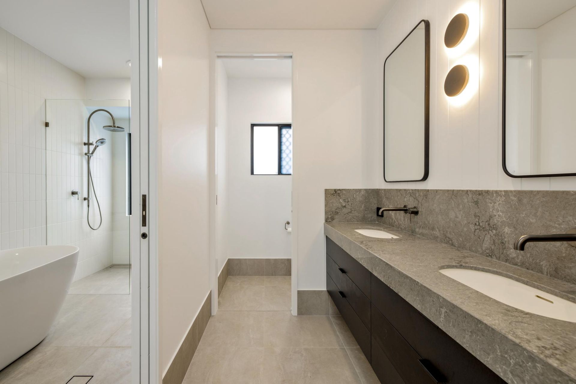 A Bathroom with Two Sinks, Two Mirrors and A Bathtub — Ashlee Jones Homes in Gordonvale, QLD