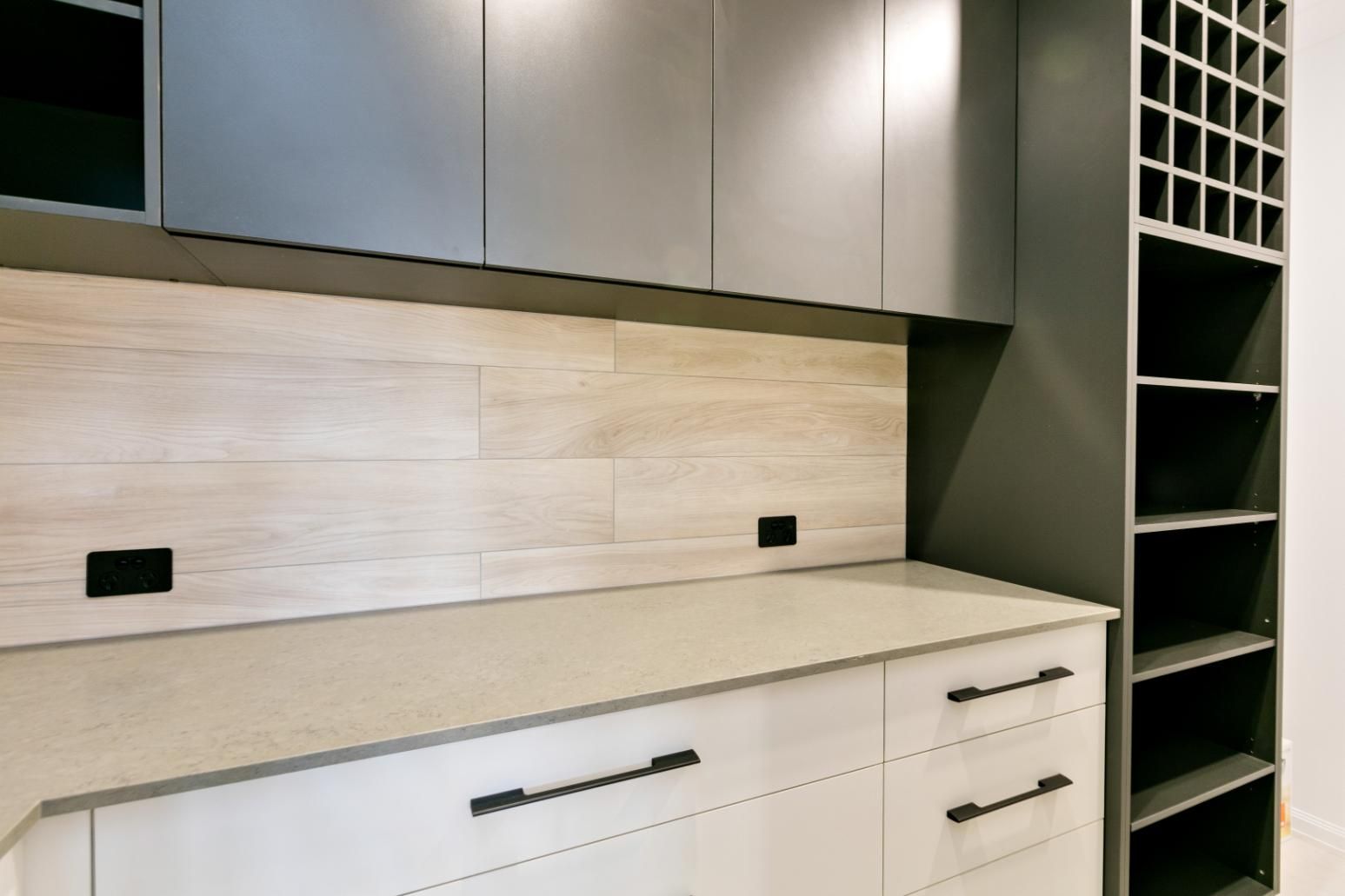 A Kitchen With White Cabinets and a Wine Rack — Ashlee Jones Homes in Gordonvale, QLD
