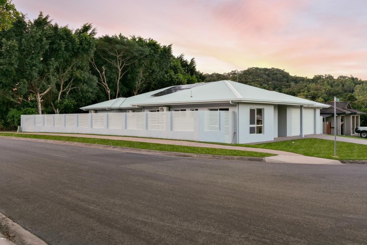 A Large White House is Sitting on the Side of a Road — Ashlee Jones Homes in Gordonvale, QLD