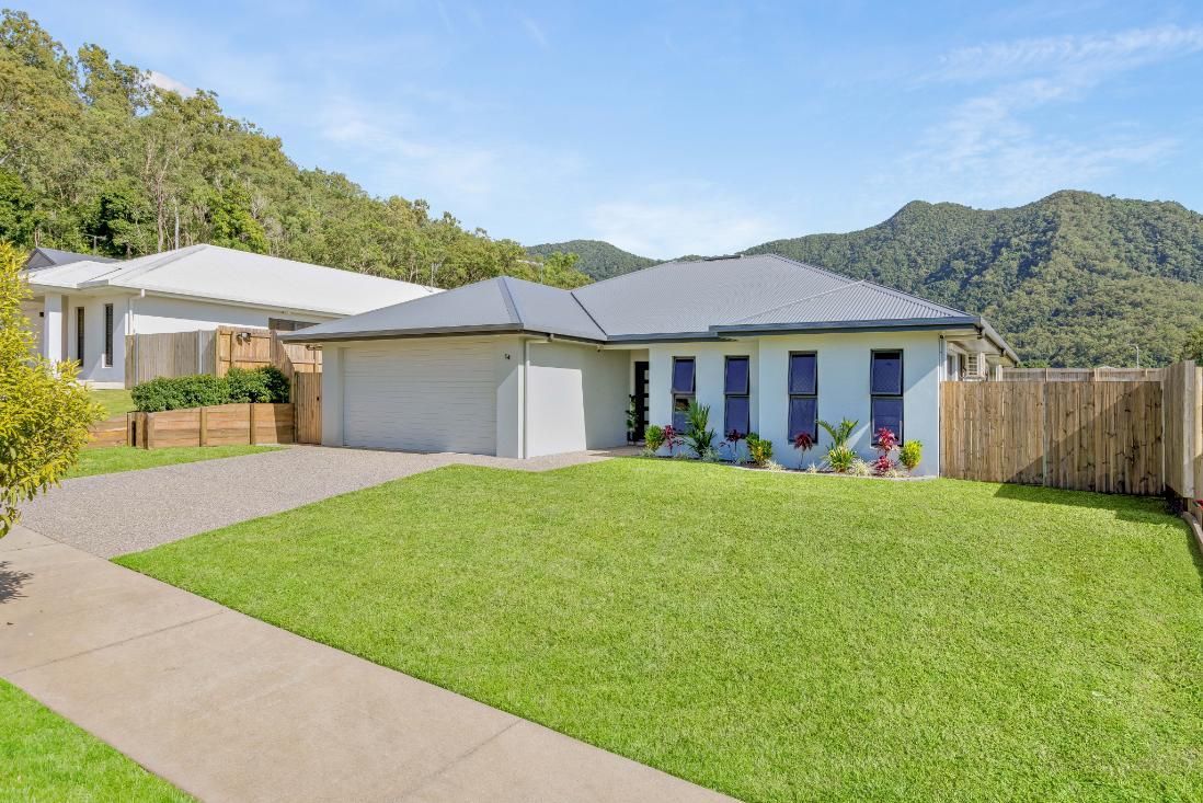 A House With a Large Lawn in Front of It and Mountains in the Background — Ashlee Jones Homes in Gordonvale, QLD