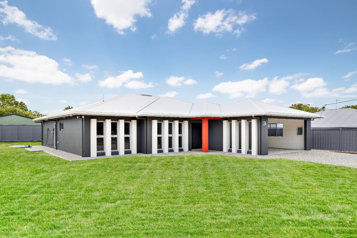 A Large House With a Large Lawn in Front of It — Ashlee Jones Homes in Gordonvale, QLD