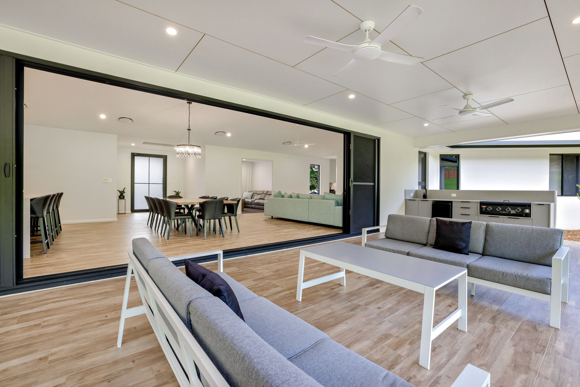 A Kitchen With Black Cabinets and White Counter Tops — Ashlee Jones Homes in Tablelands, QLD