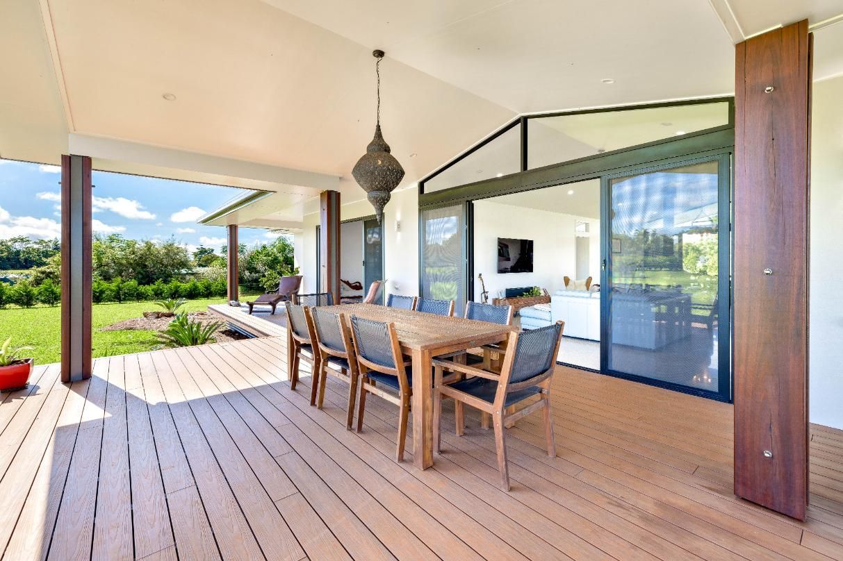 There is a Table and Chairs on the Deck of a House — Ashlee Jones Homes in Gordonvale, QLD