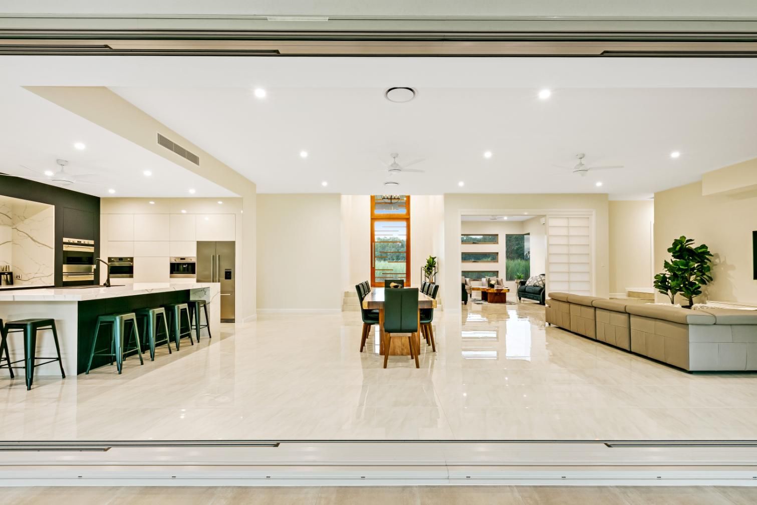A Large House With a Kitchen, Dining Room, Living Room and Sliding Glass doors — Ashlee Jones Homes in Gordonvale, QLD