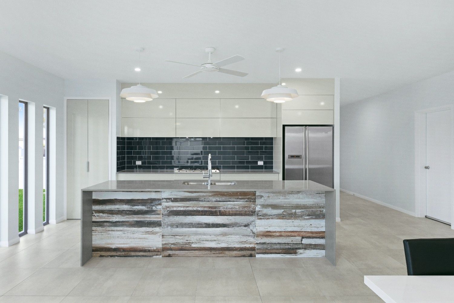 A Kitchen With a Large Island in the Middle of It — Ashlee Jones Homes in Gordonvale, QLD