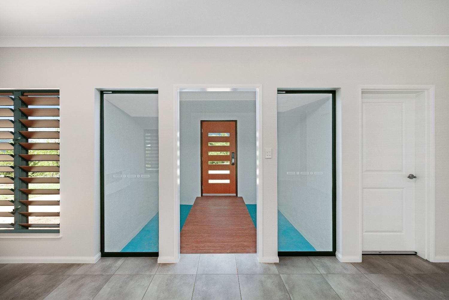 A Hallway in a House With a Wooden Door — Ashlee Jones Homes in Gordonvale, QLD