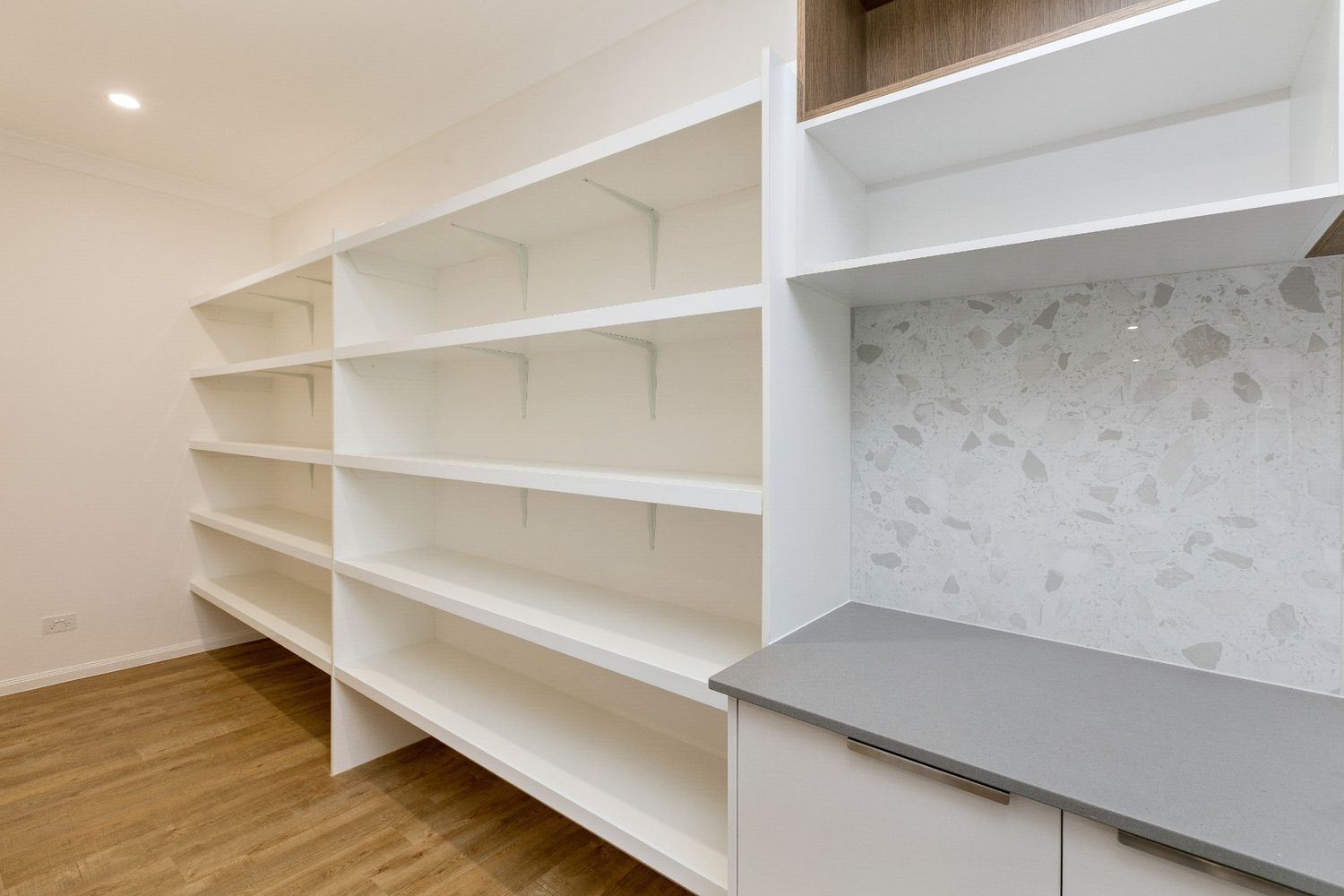A Kitchen With a Lot of Shelves and a Counter Top — Ashlee Jones Homes in Gordonvale, QLD