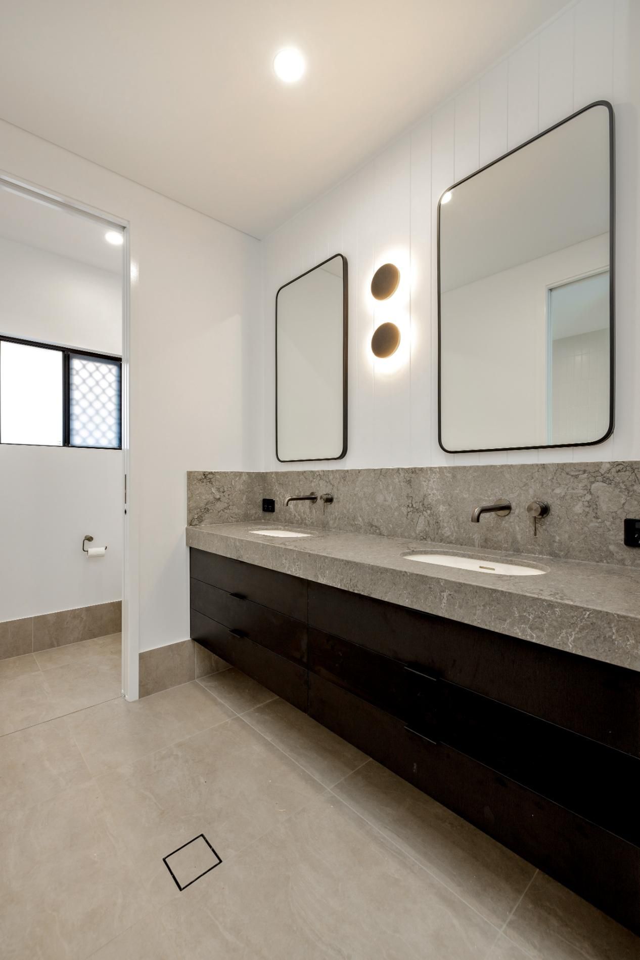 A Bathroom with Two Sinks and Two Mirrors — Ashlee Jones Homes in Gordonvale, QLD