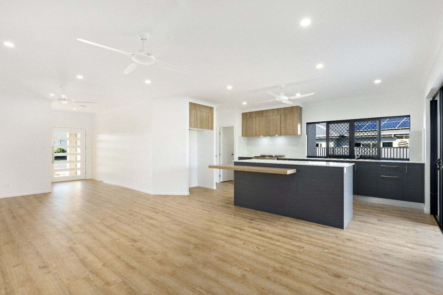 A Kitchen With a Large Island in the Middle of the Room — Ashlee Jones Homes in Gordonvale, QLD