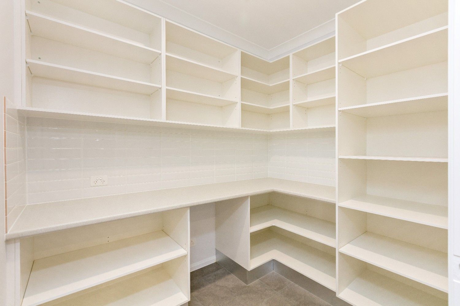 An Empty Pantry With Lots of Shelves and a Desk — Ashlee Jones Homes in Gordonvale, QLD