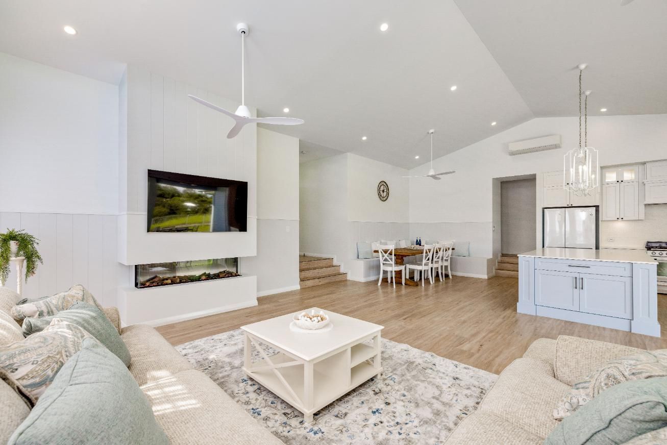 A Living Room Filled With Furniture and a Flat Screen Tv — Ashlee Jones Homes in Gordonvale, QLD