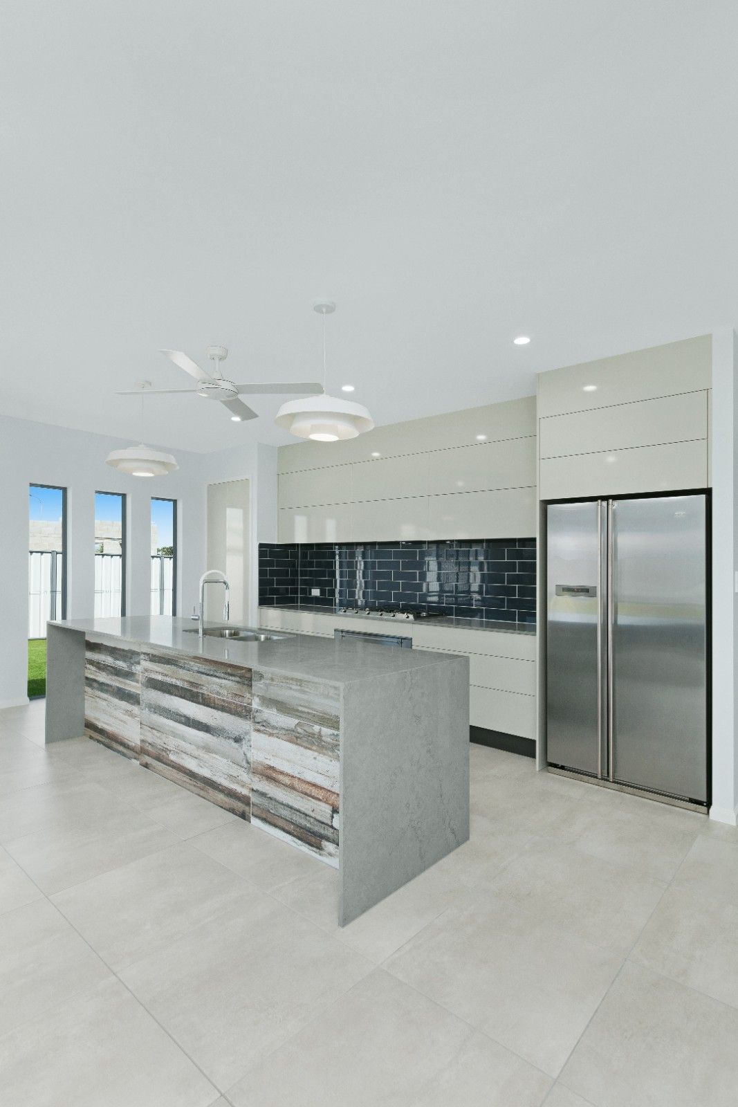 A Kitchen With Stainless Steel Appliances — Ashlee Jones Homes in Gordonvale, QLD