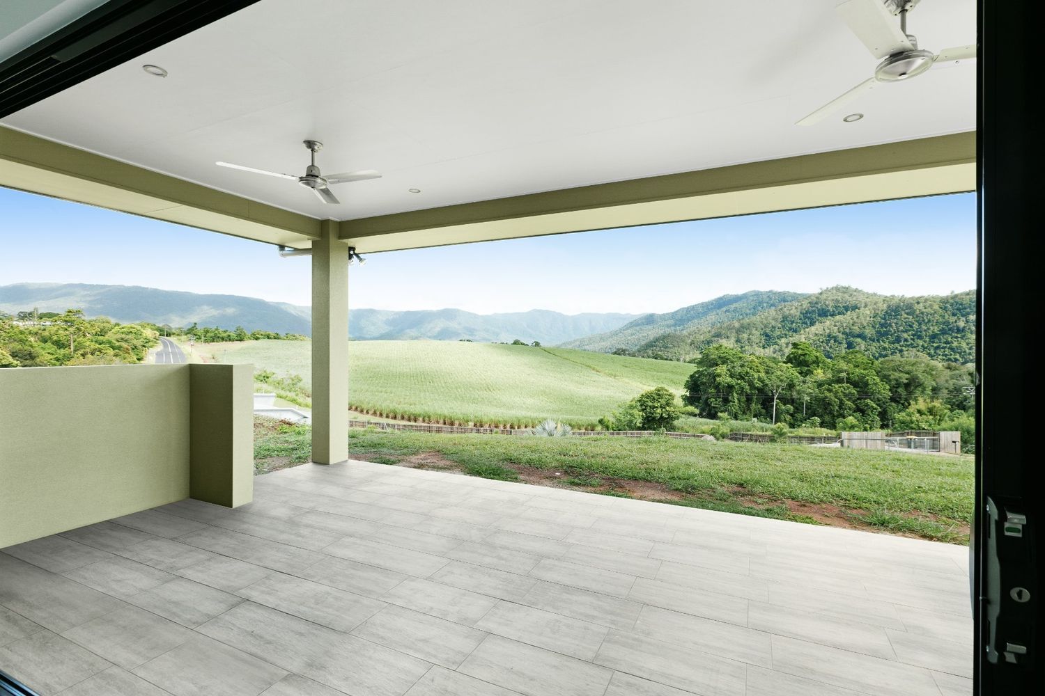 An Empty Patio With a View of Mountains and Trees — Ashlee Jones Homes in Gordonvale, QLD