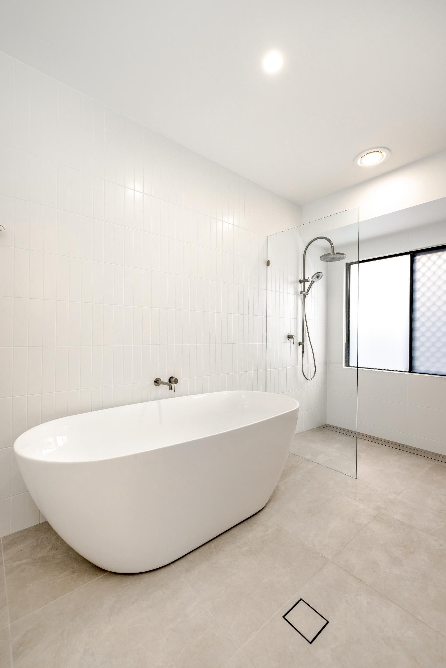 A Bathroom with A Bathtub and A Shower — Ashlee Jones Homes in Gordonvale, QLD