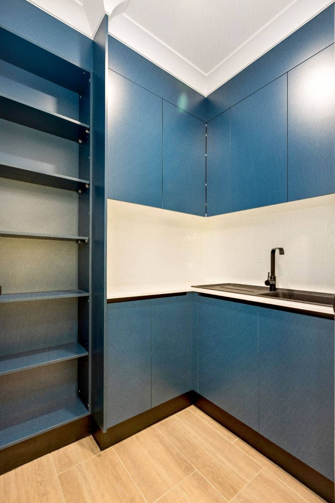 An Empty Room With Sliding Glass Doors and a Ceiling Fan — Ashlee Jones Homes in Gordonvale, QLD