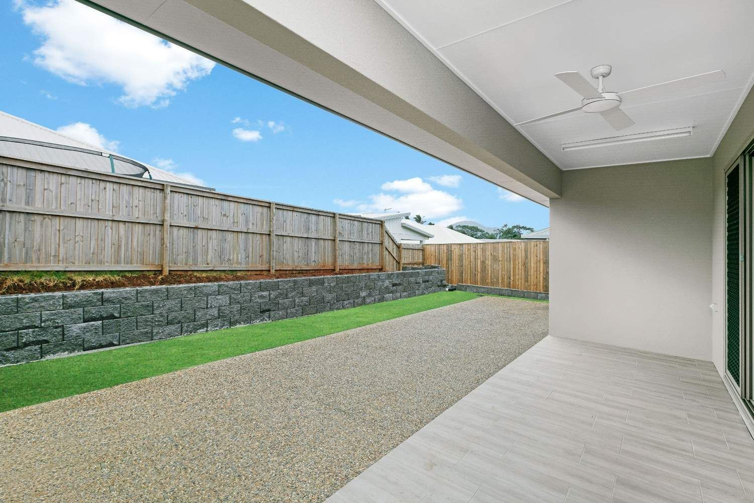 A Patio With a Ceiling Fan and a Fence in the Background — Ashlee Jones Homes in Gordonvale, QLD