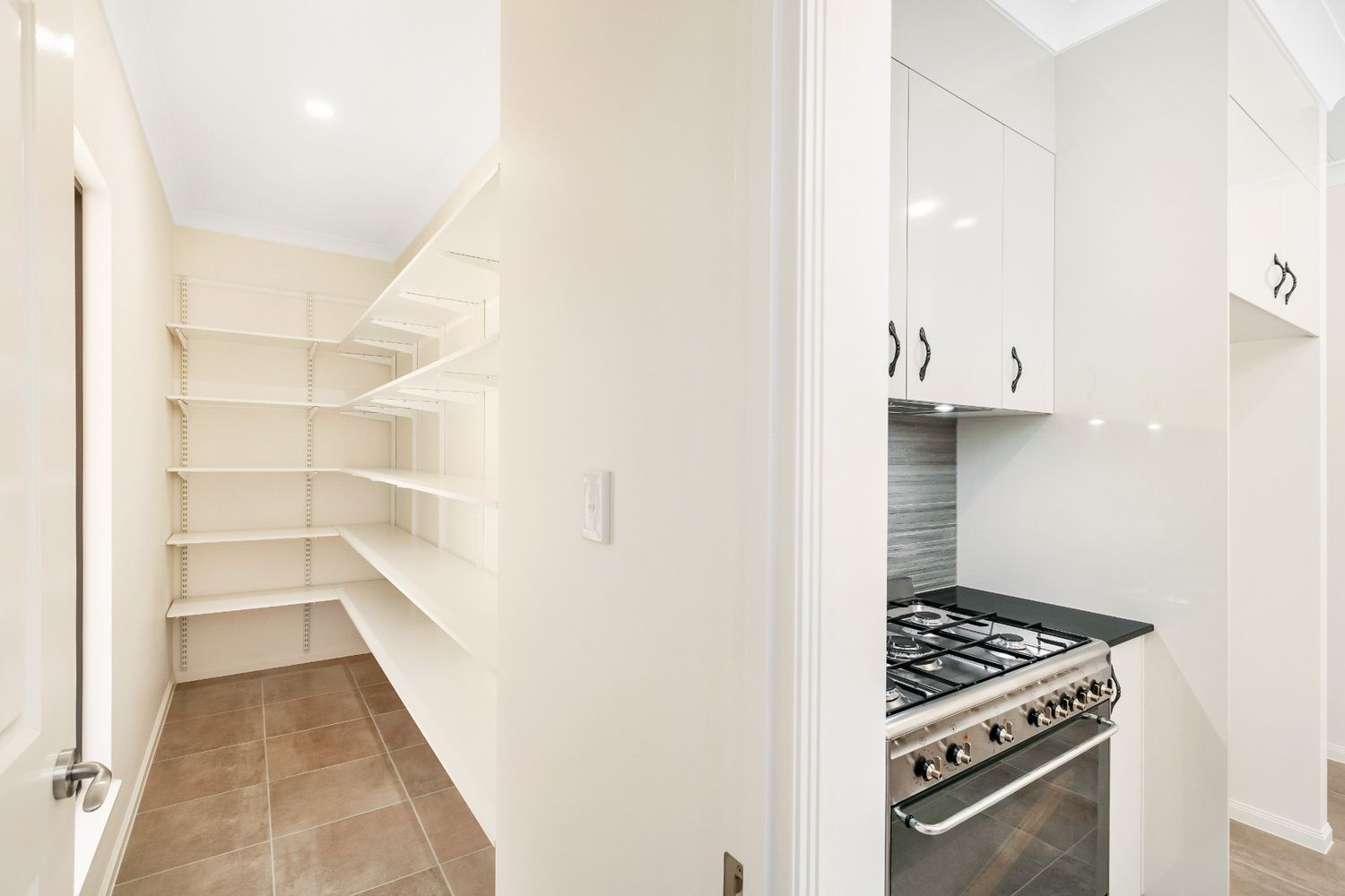A Kitchen With a Pantry and a Stove — Ashlee Jones Homes in Gordonvale, QLD