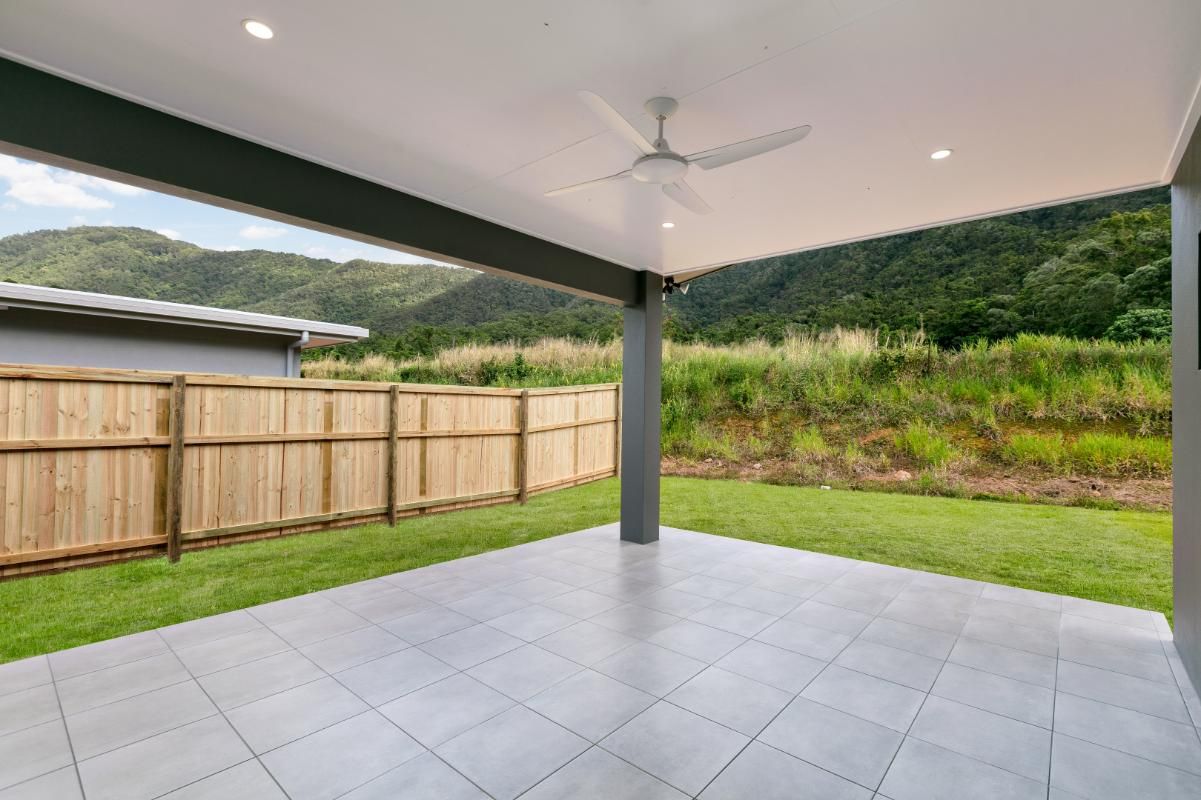 An Empty Patio With a Ceiling Fan and a Wooden Fence — Ashlee Jones Homes in Gordonvale, QLD