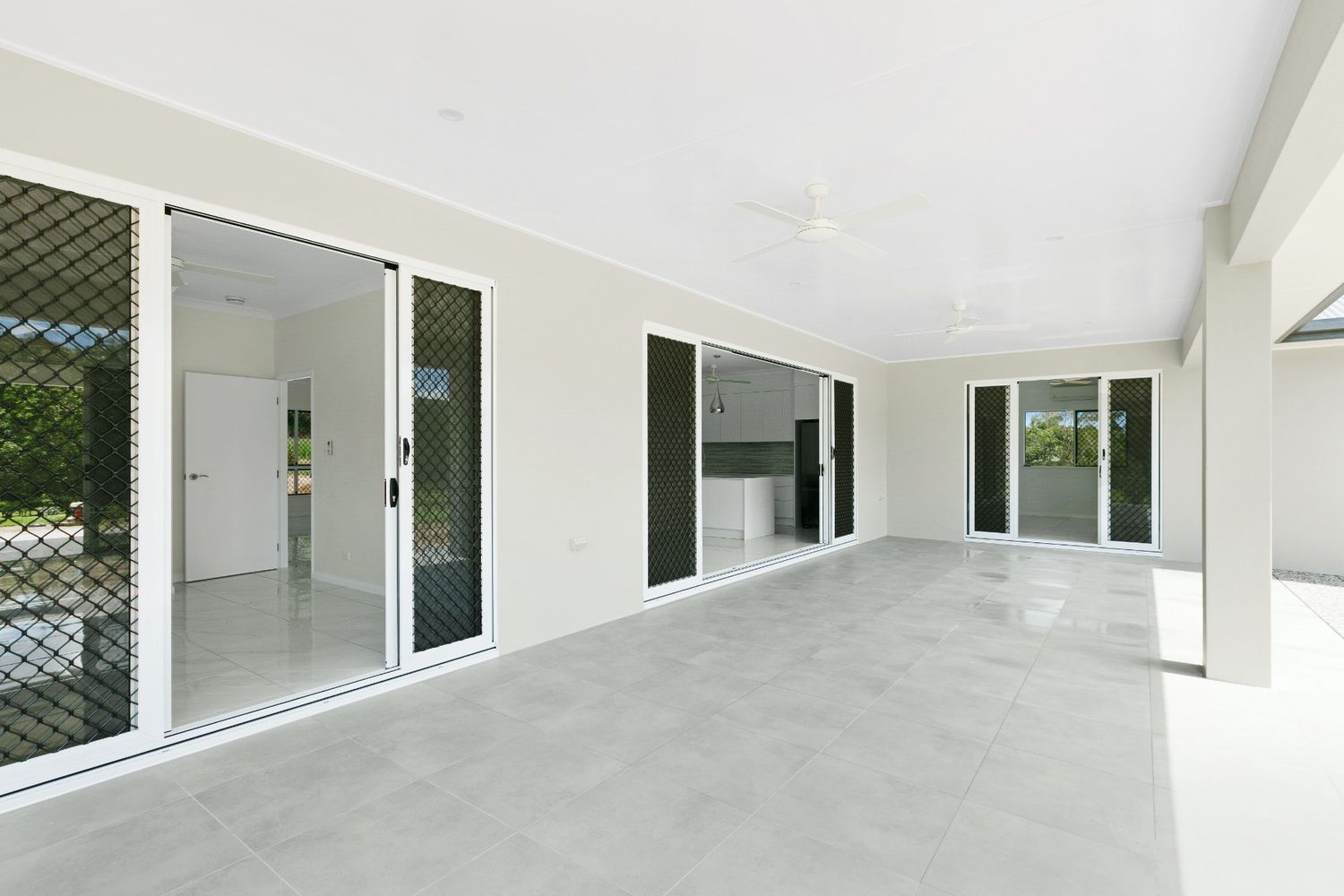 An Empty Room With a Lot of Windows and Doors — Ashlee Jones Homes in Gordonvale, QLD