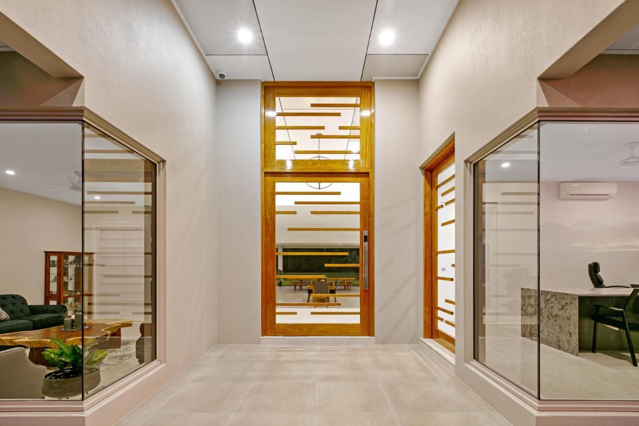 A Hallway With a Large Door and a Lot of Windows — Ashlee Jones Homes in Gordonvale, QLD