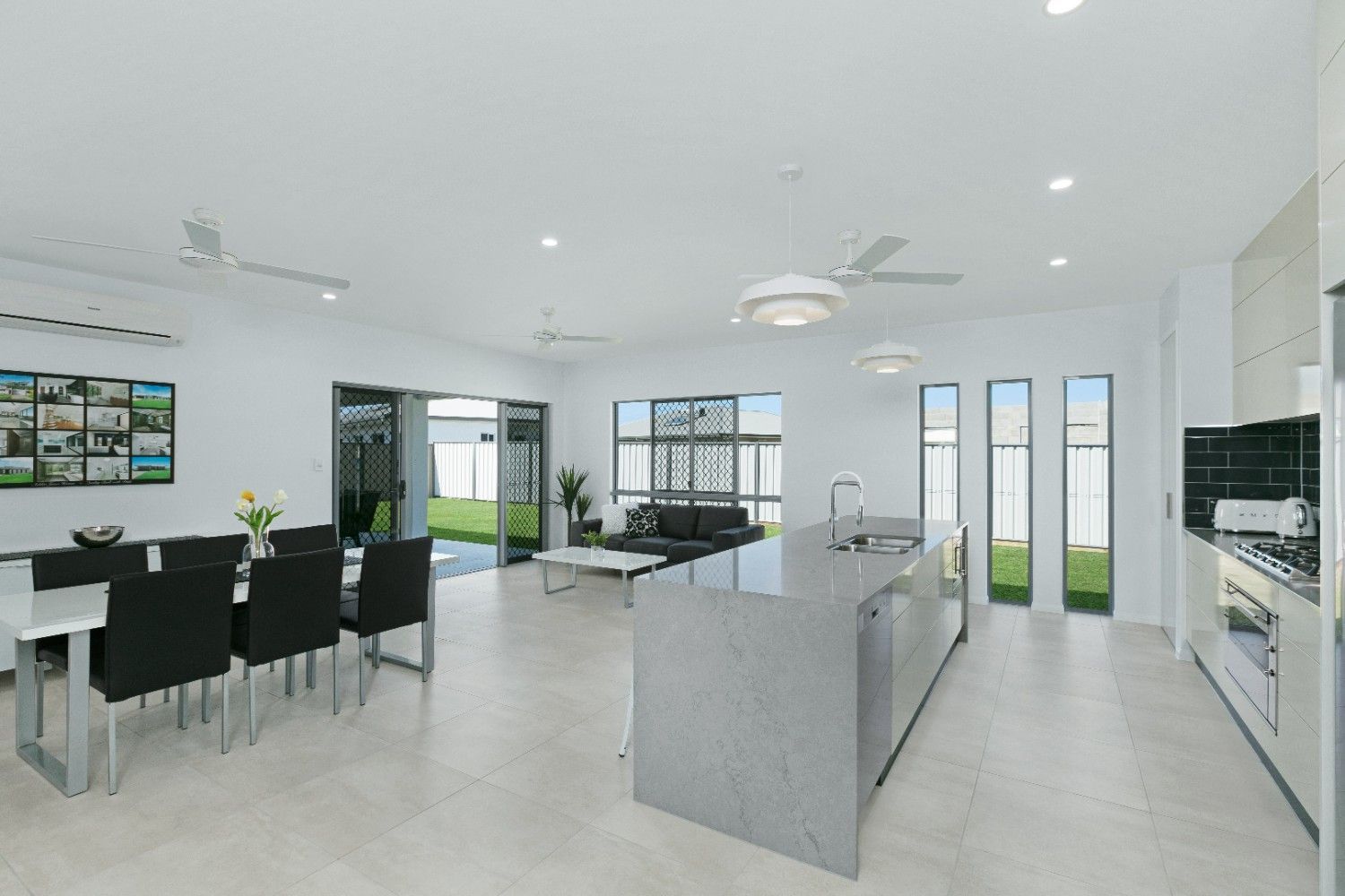 A Living Room With a Dining Table and Chairs and a Kitchen — Ashlee Jones Homes in Gordonvale, QLD