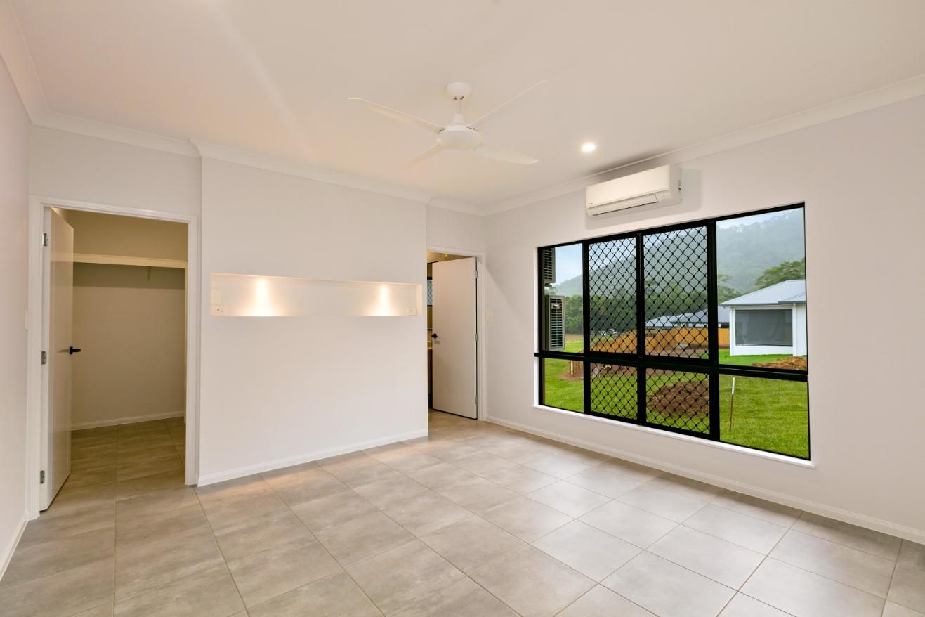 An Empty Room With a Large Window and a Ceiling Fan — Ashlee Jones Homes in Gordonvale, QLD