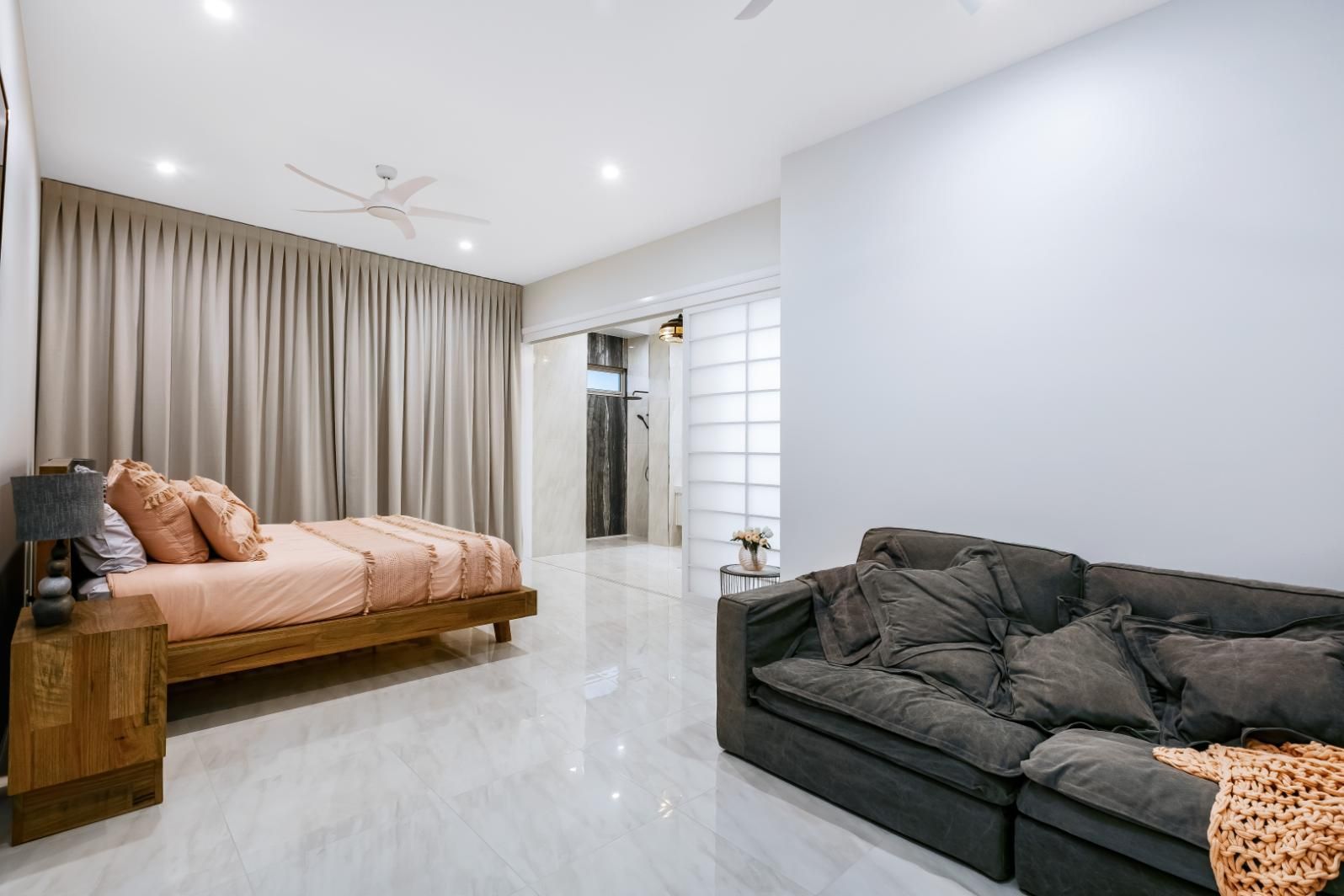 A Bedroom With a Bed and a Couch in It — Ashlee Jones Homes in Gordonvale, QLD
