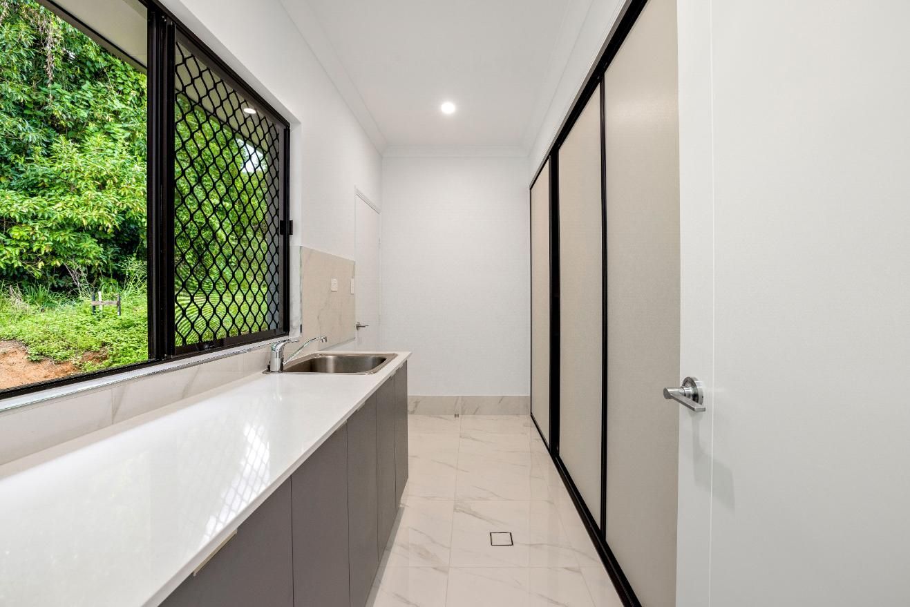 A Laundry Room With a Sink and a Window — Ashlee Jones Homes in Gordonvale, QLD