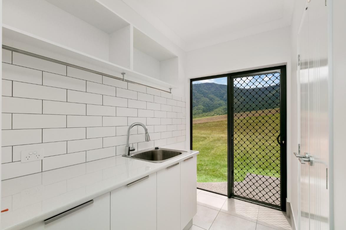 A Kitchen With a Sink and a Sliding Glass Door — Ashlee Jones Homes in Gordonvale, QLD
