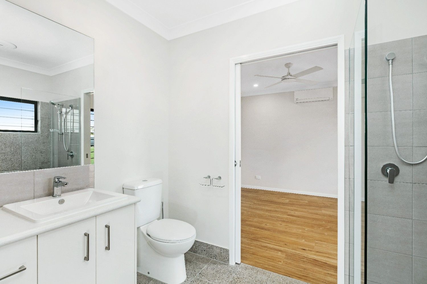 A Bathroom With a Toilet, Sink and Shower — Ashlee Jones Homes in Gordonvale, QLD