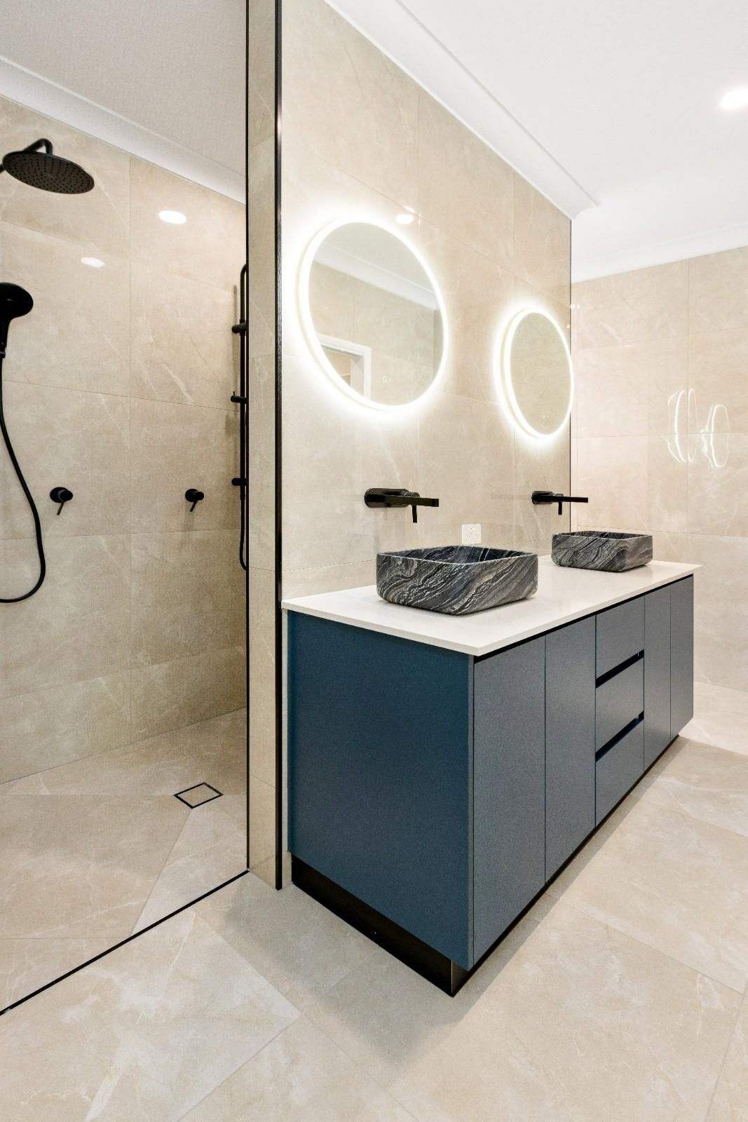 A Bathroom With Two Sinks and a Shower — Ashlee Jones Homes in Gordonvale, QLD