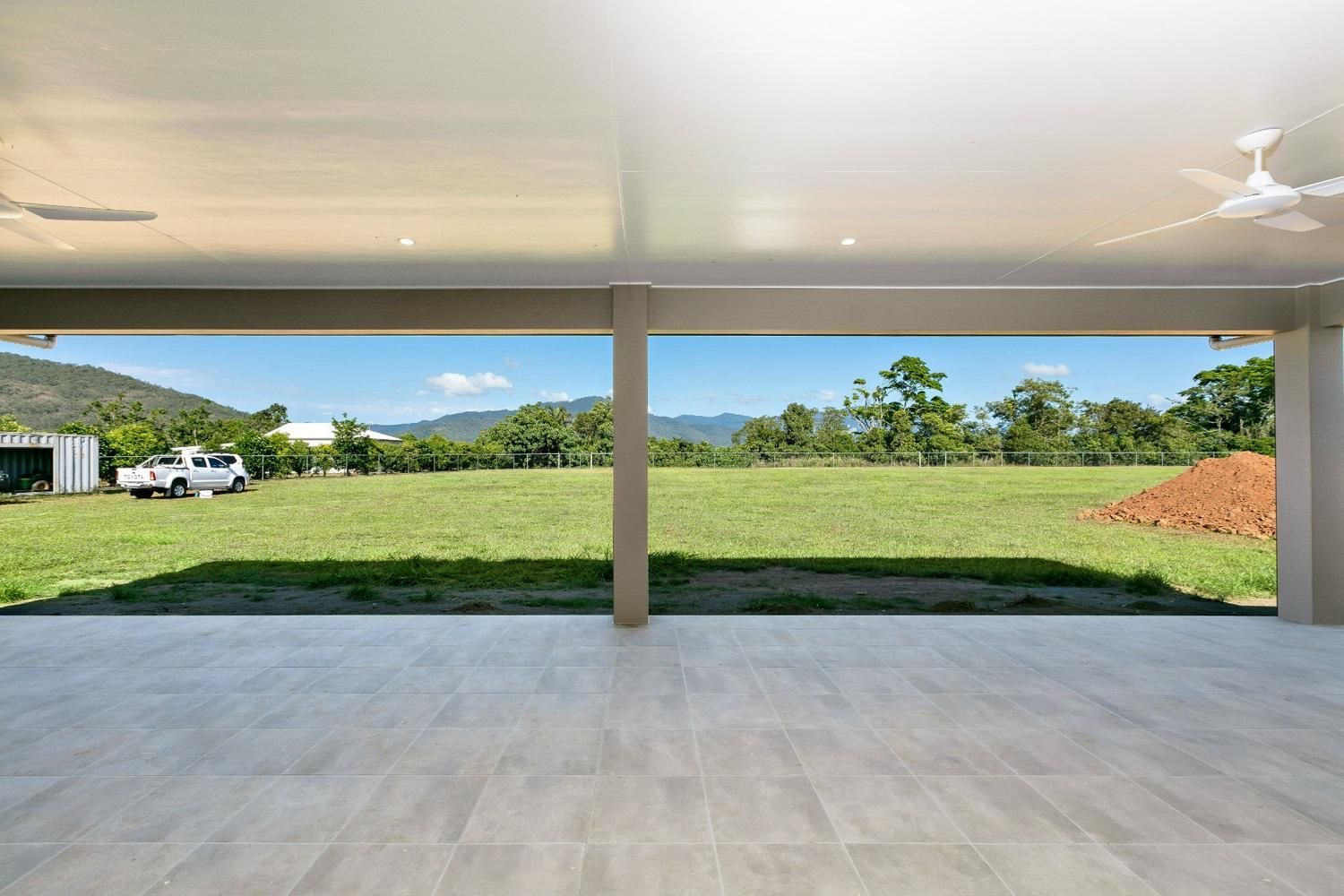 A Large Empty Room With a View of a Grassy Field — Ashlee Jones Homes in Gordonvale, QLD