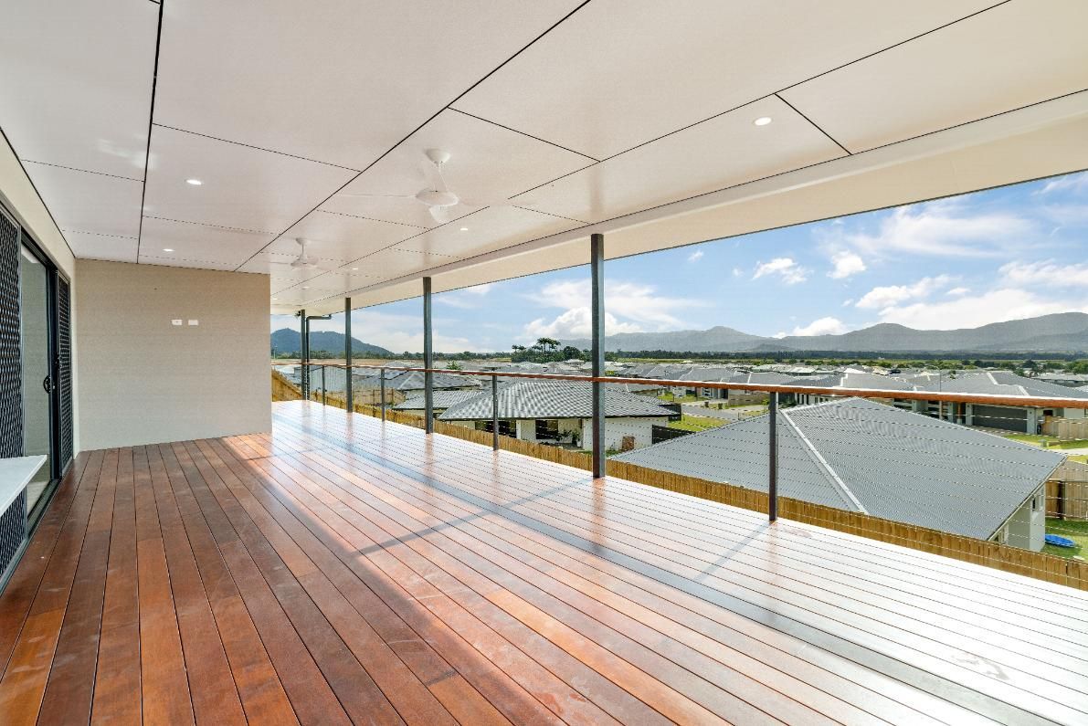 An Empty Deck With a View of a City and Mountains — Ashlee Jones Homes in Gordonvale, QLD
