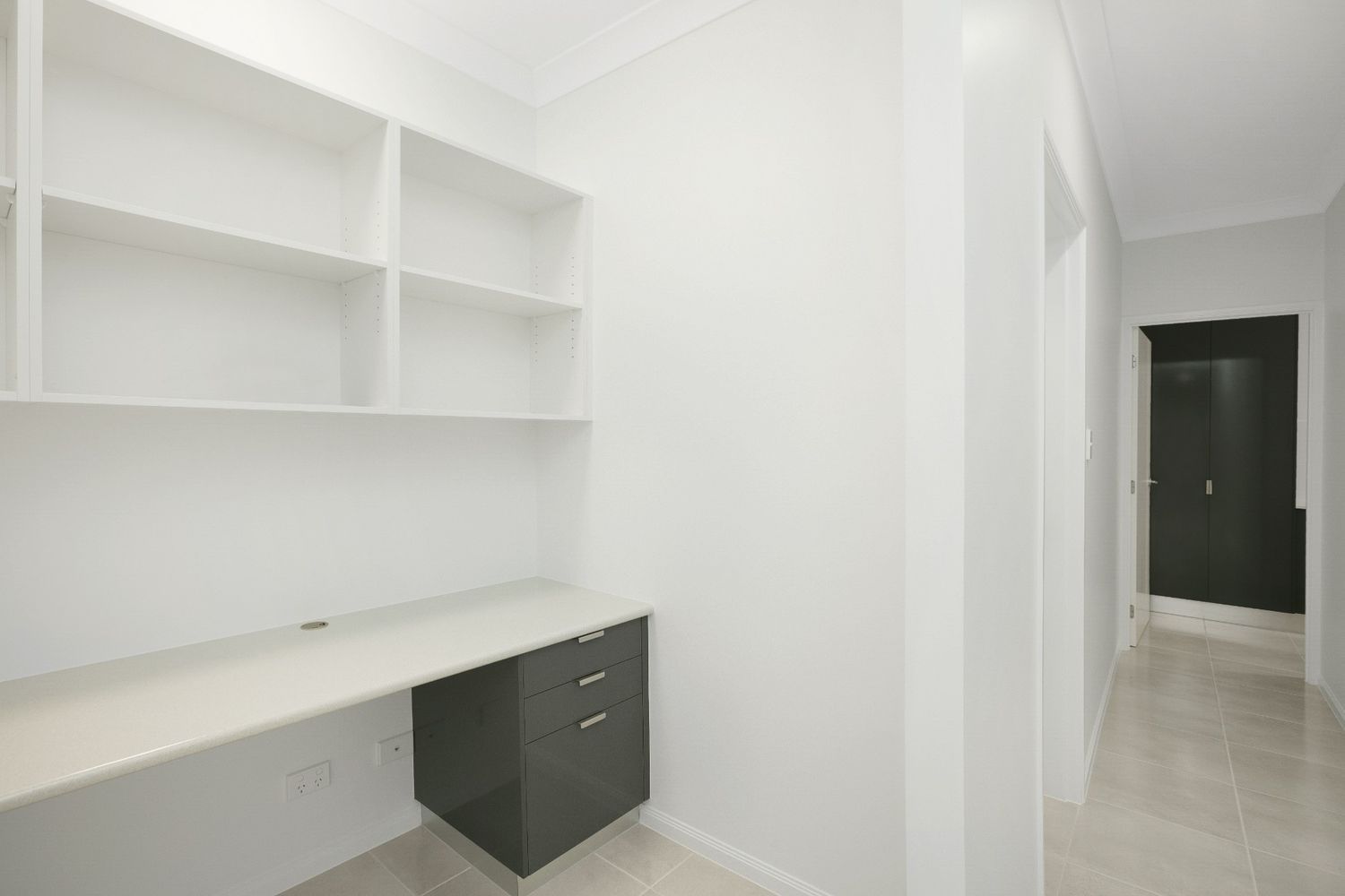 An Empty Room With a Desk and Shelves in It — Ashlee Jones Homes in Gordonvale, QLD