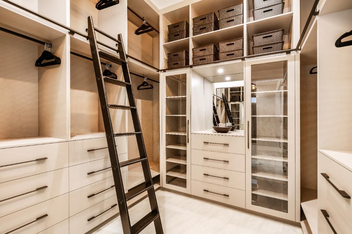 A Walk in Closet With a Ladder and Lots of Shelves — Ashlee Jones Homes in Gordonvale, QLD