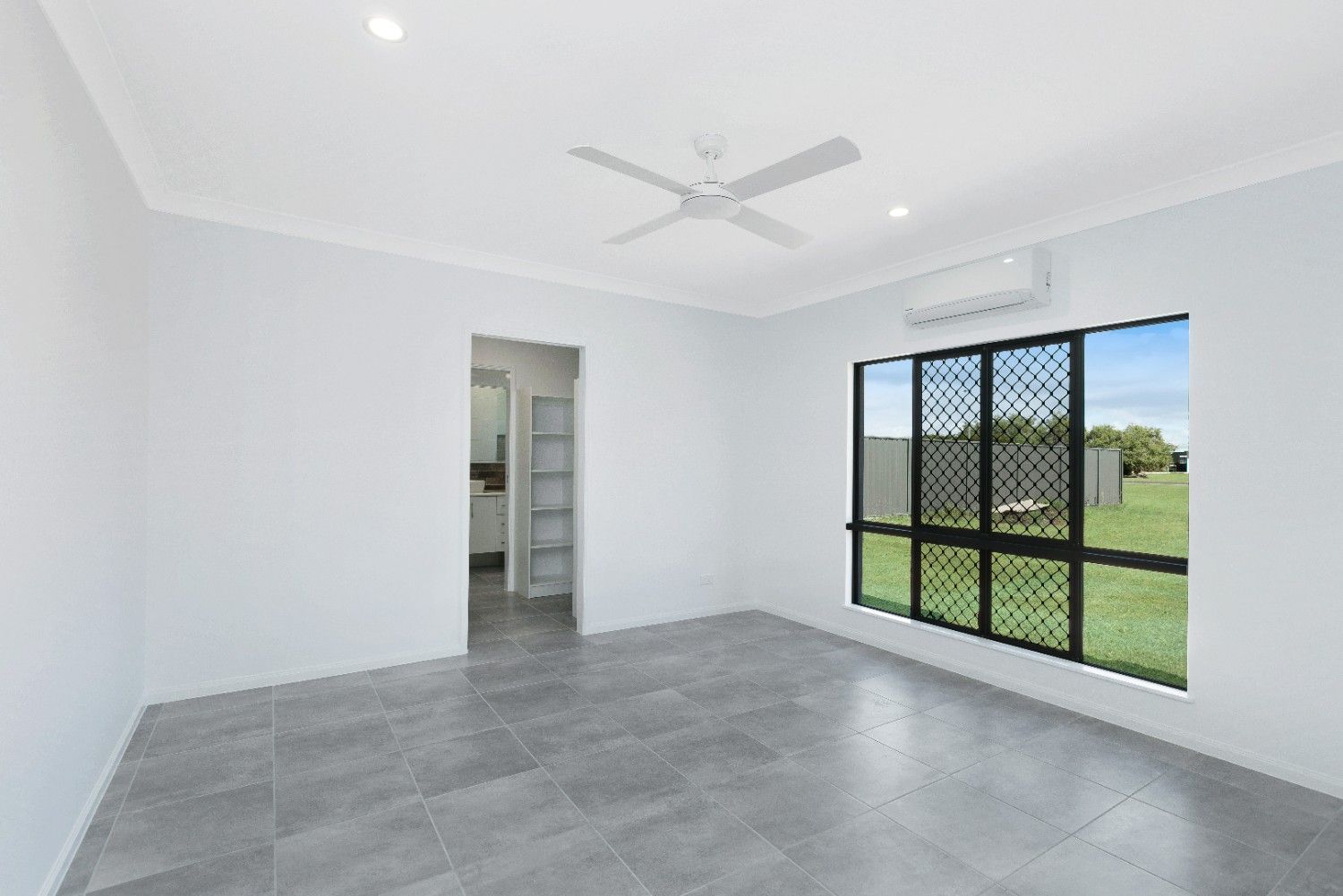 An Living Room With a Ceiling Fan and a Window — Ashlee Jones Homes in Gordonvale, QLD